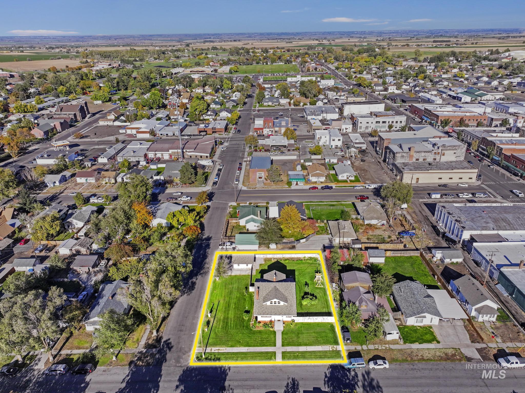 Aerial overview of property's location with property parcel outlined and nearby suburban area