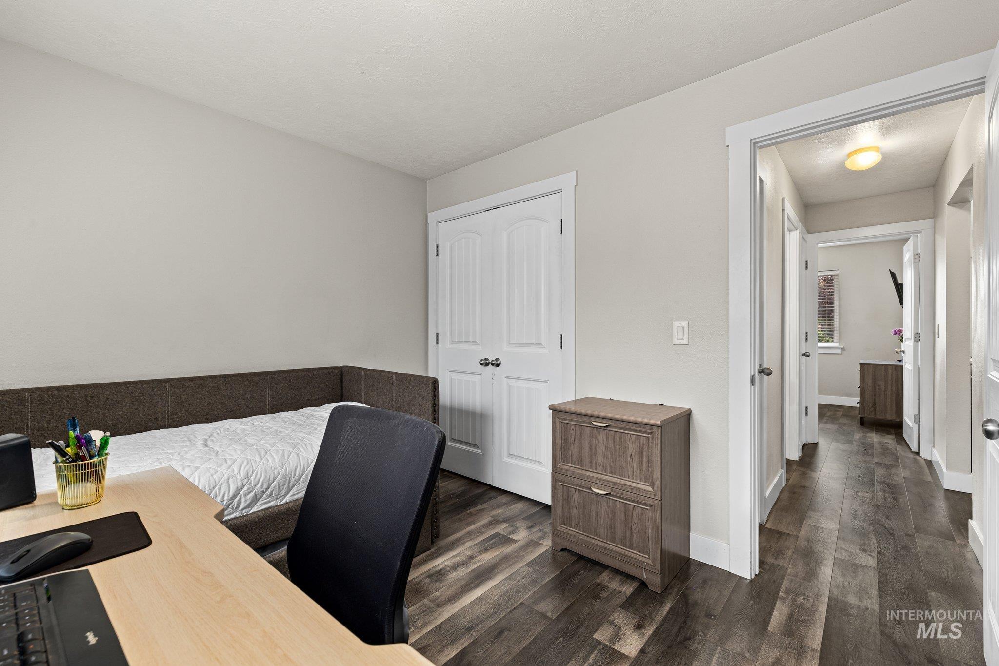 Office area featuring dark wood finished floors and baseboards