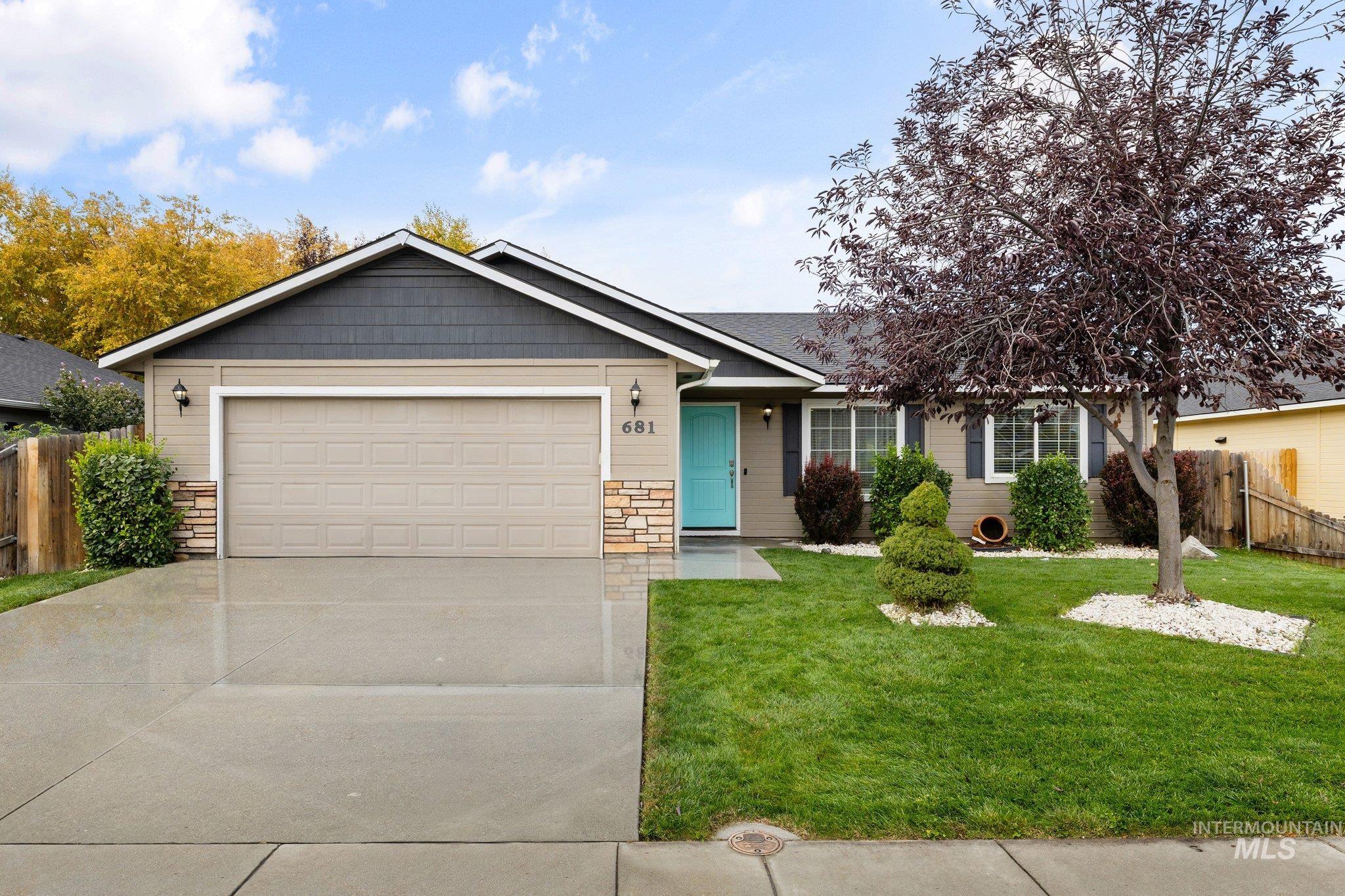 Ranch-style house with driveway, stone siding, a garage, and a shingled roof