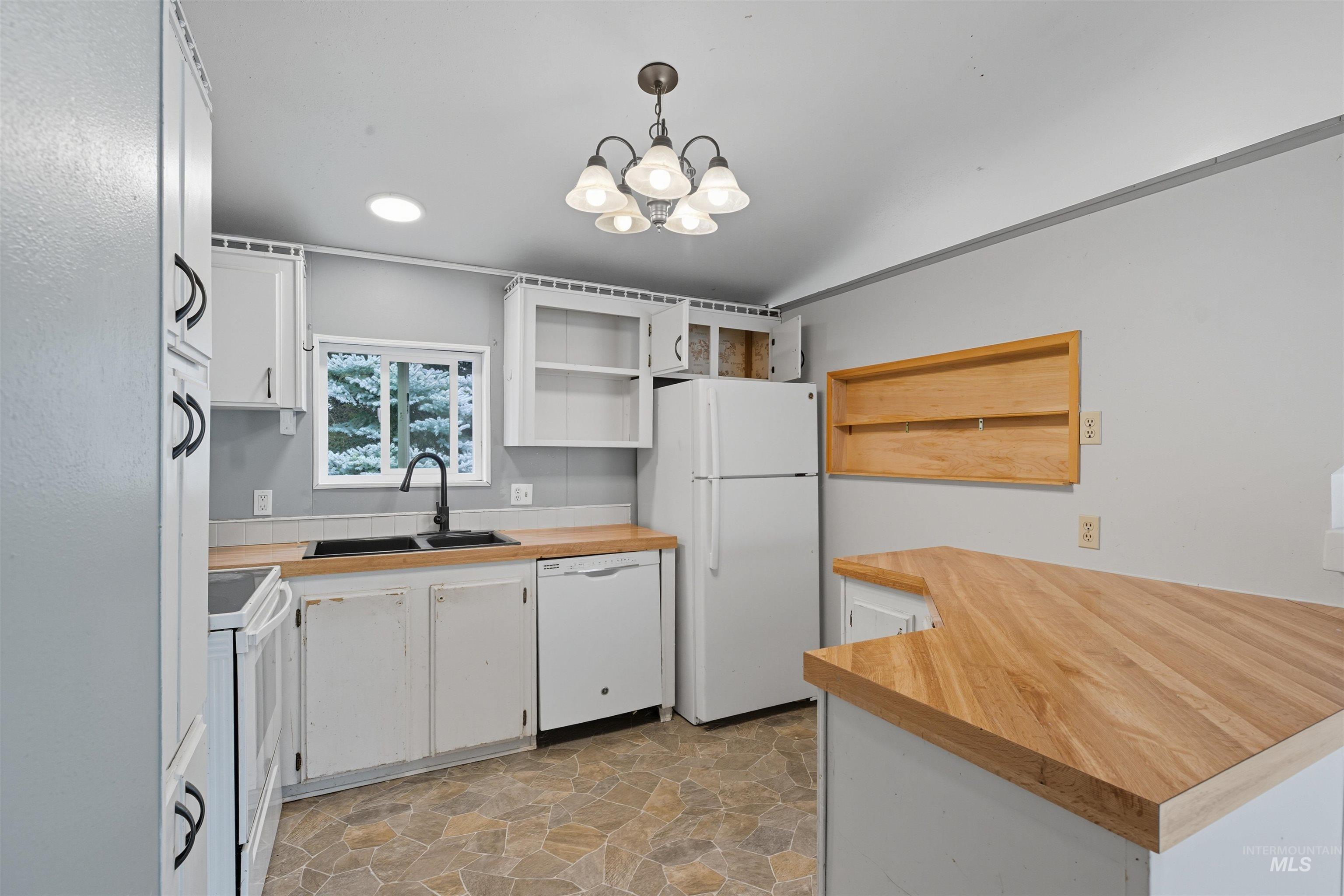 Kitchen featuring white cabinets, open shelves, white appliances, and wood counters