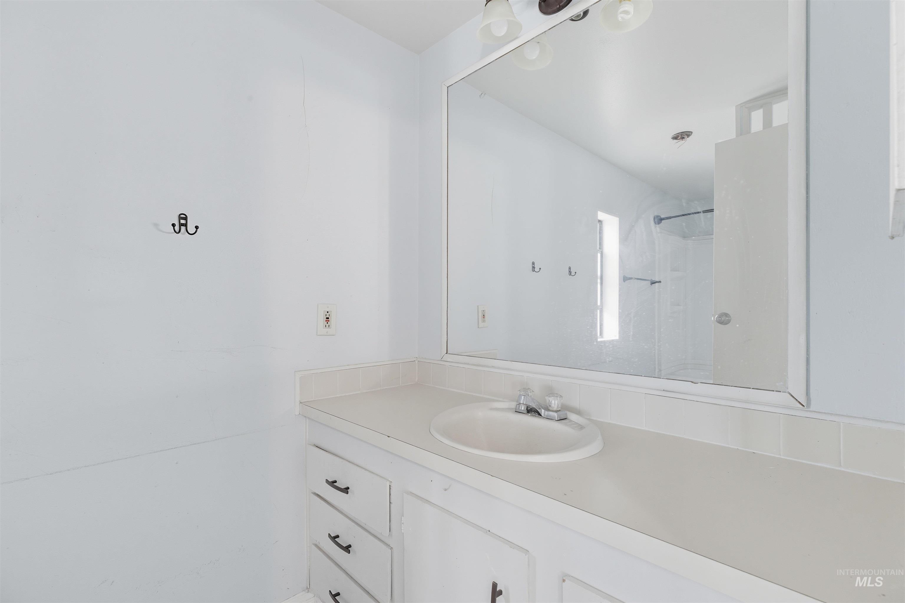 Bathroom featuring vanity and a shower