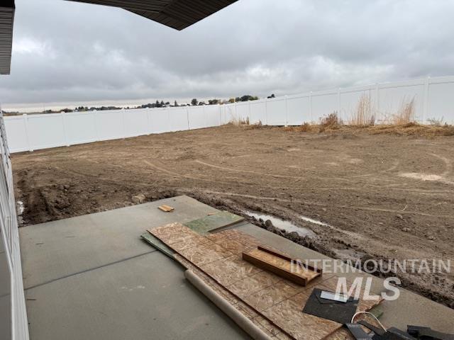 Entry to storm shelter featuring a fenced backyard