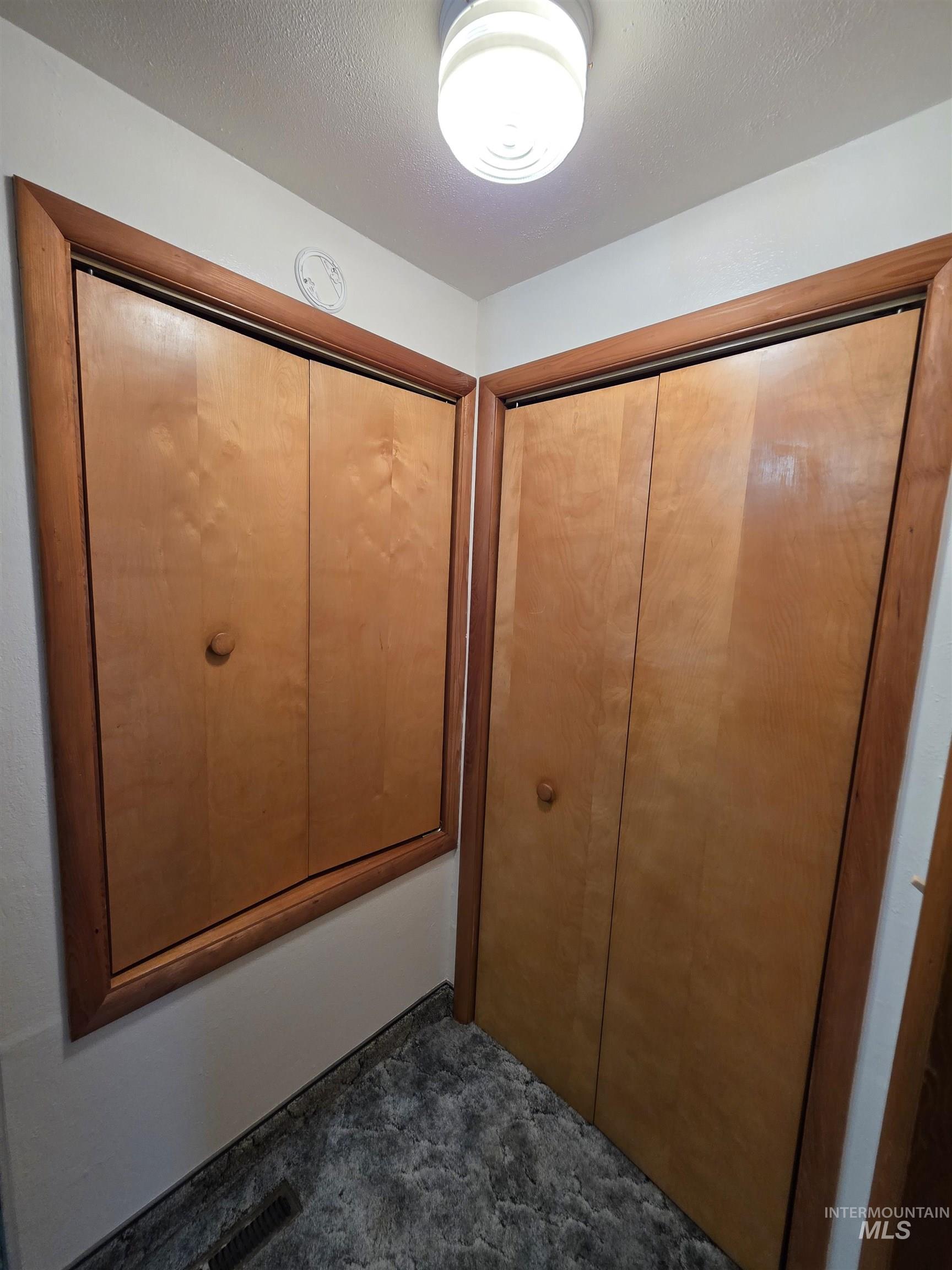 Unfurnished bedroom with a closet and a textured ceiling