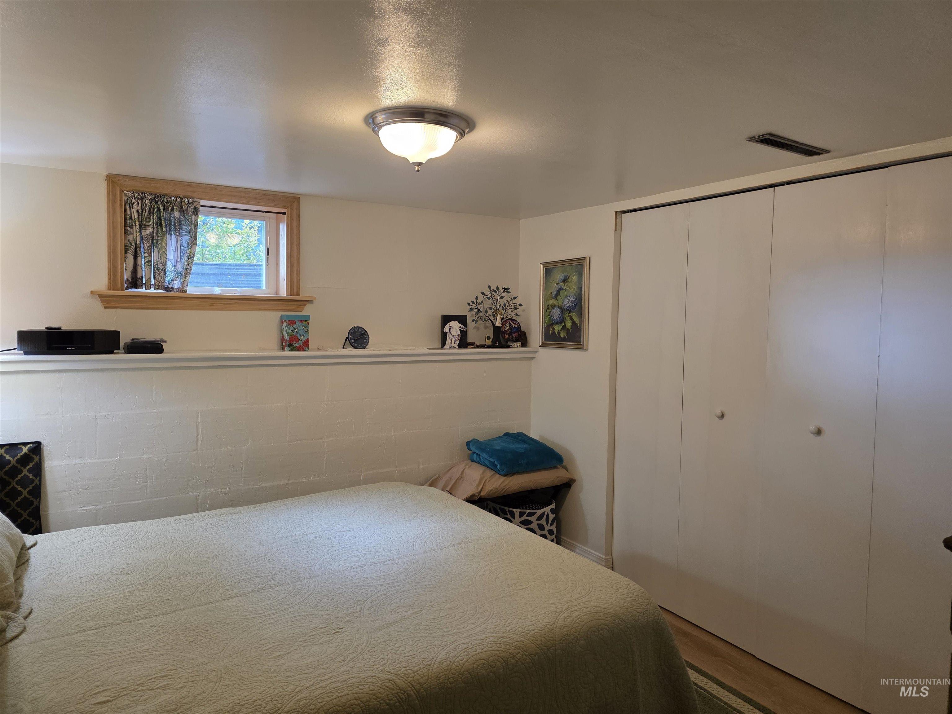 Bedroom with a closet and wood finished floors