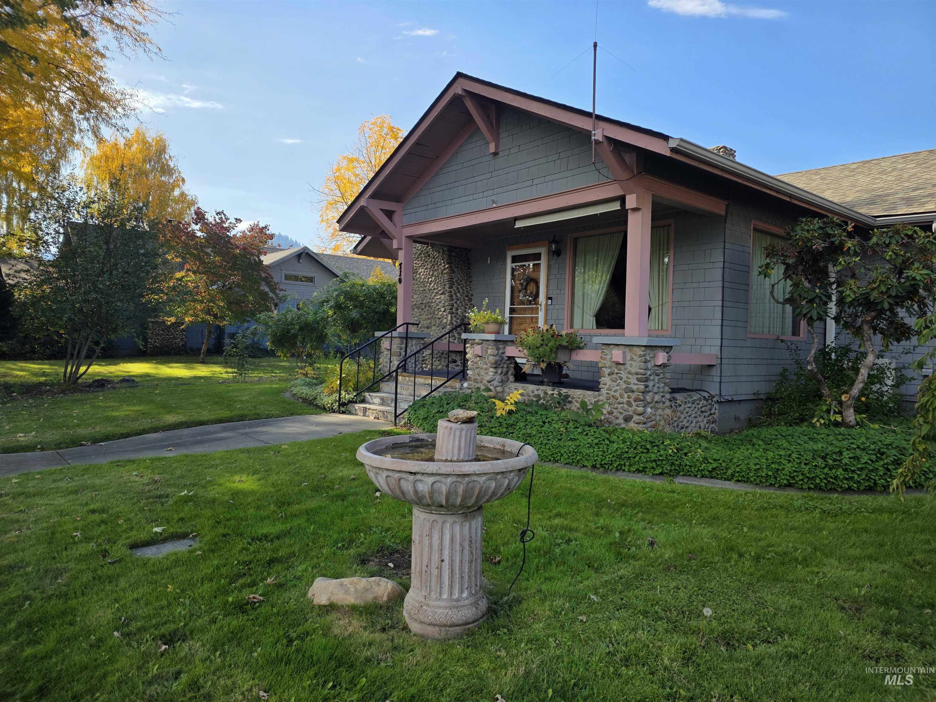 Bungalow-style home with a porch and a front lawn