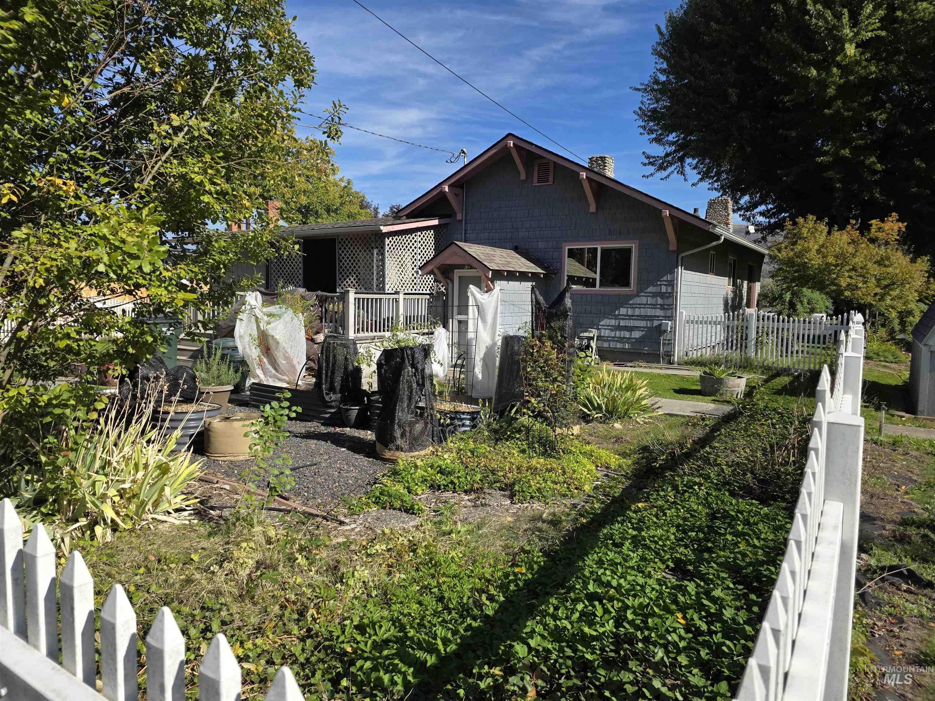 Bungalow-style home with a chimney and a deck