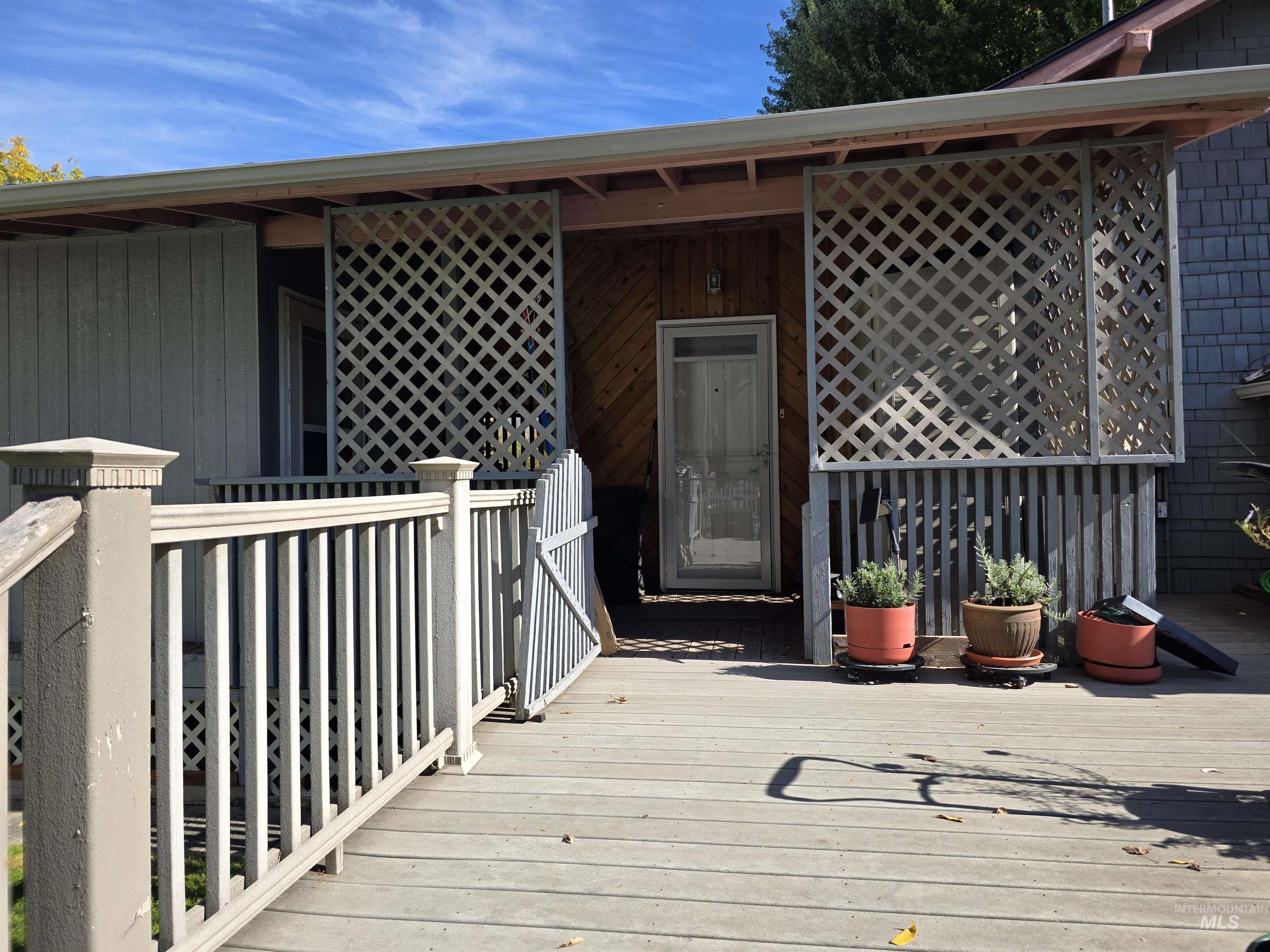 View of exterior entry featuring a wooden deck