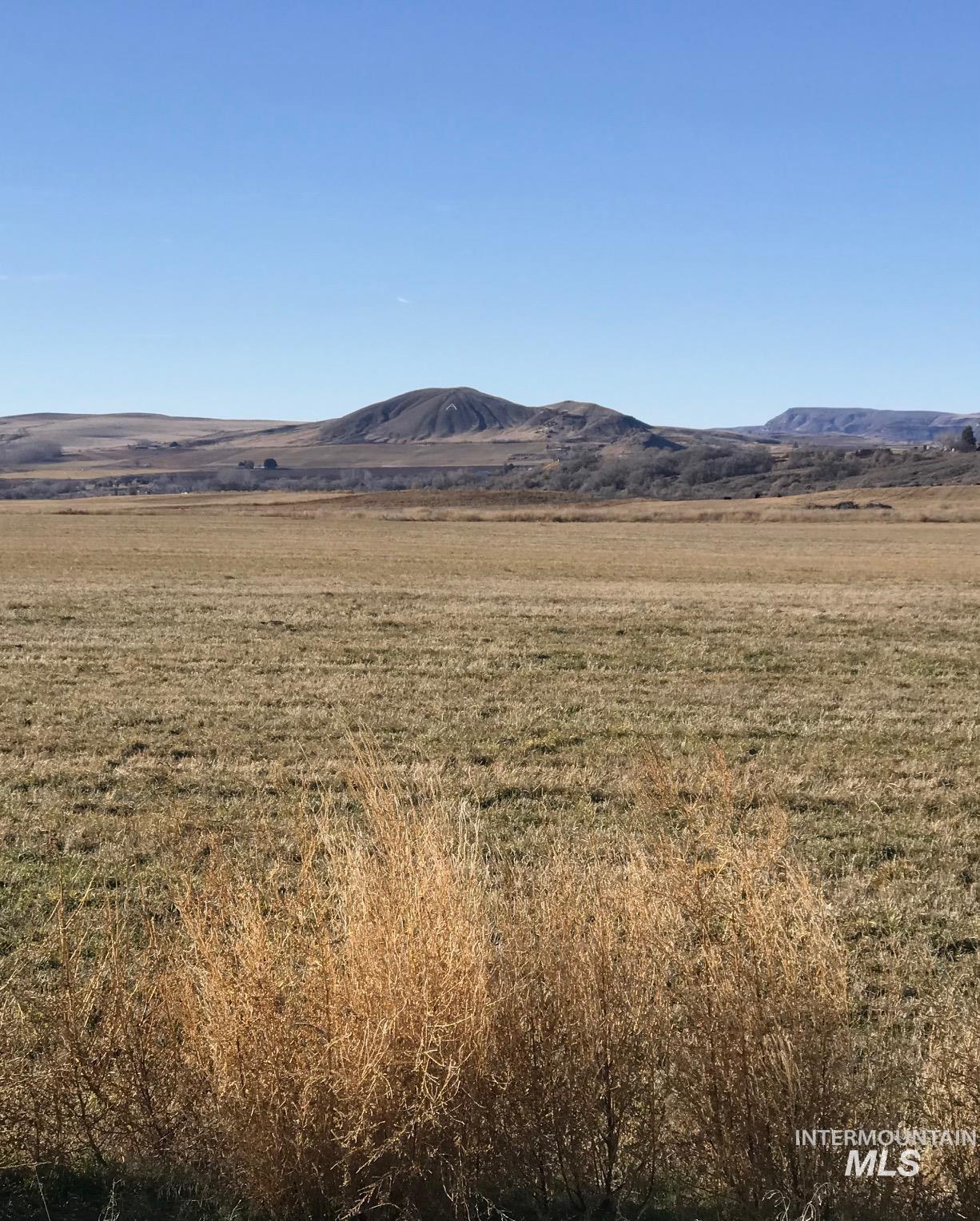 View of mountain backdrop with rural landscape