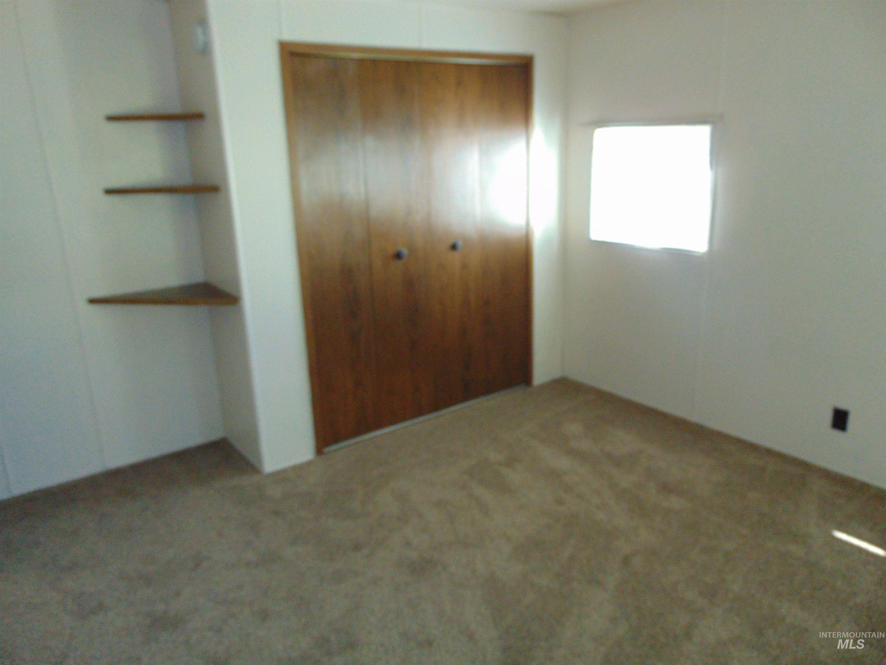 Unfurnished bedroom with carpet floors and a closet