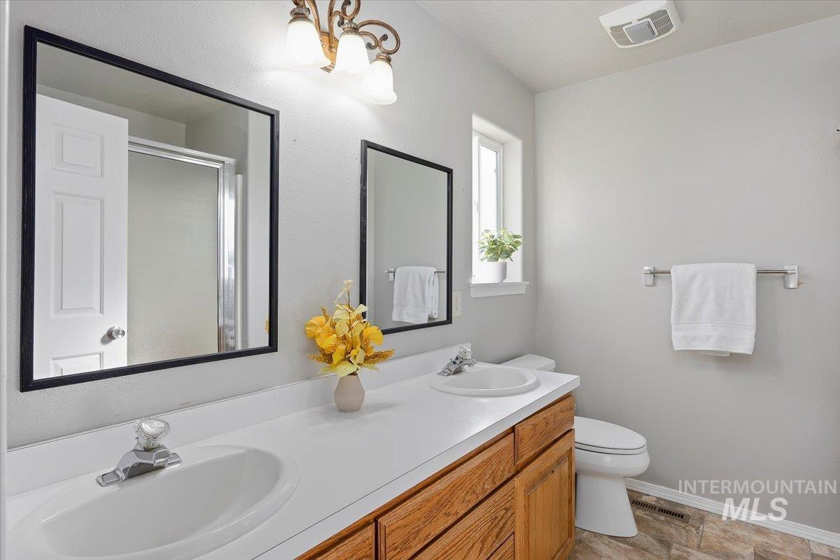 Bathroom with double vanity and a stall shower
