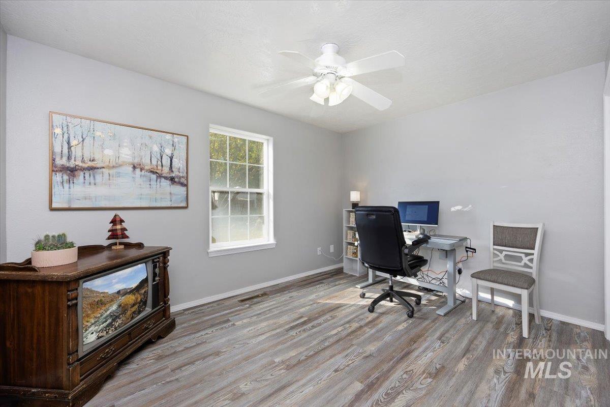 Office featuring wood finished floors and a ceiling fan