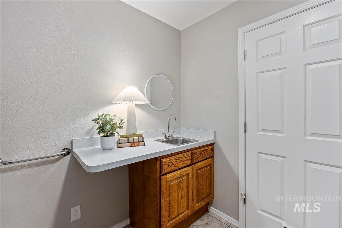 Bathroom featuring vanity and baseboards