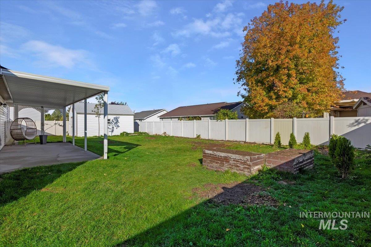 Fenced backyard with a garden