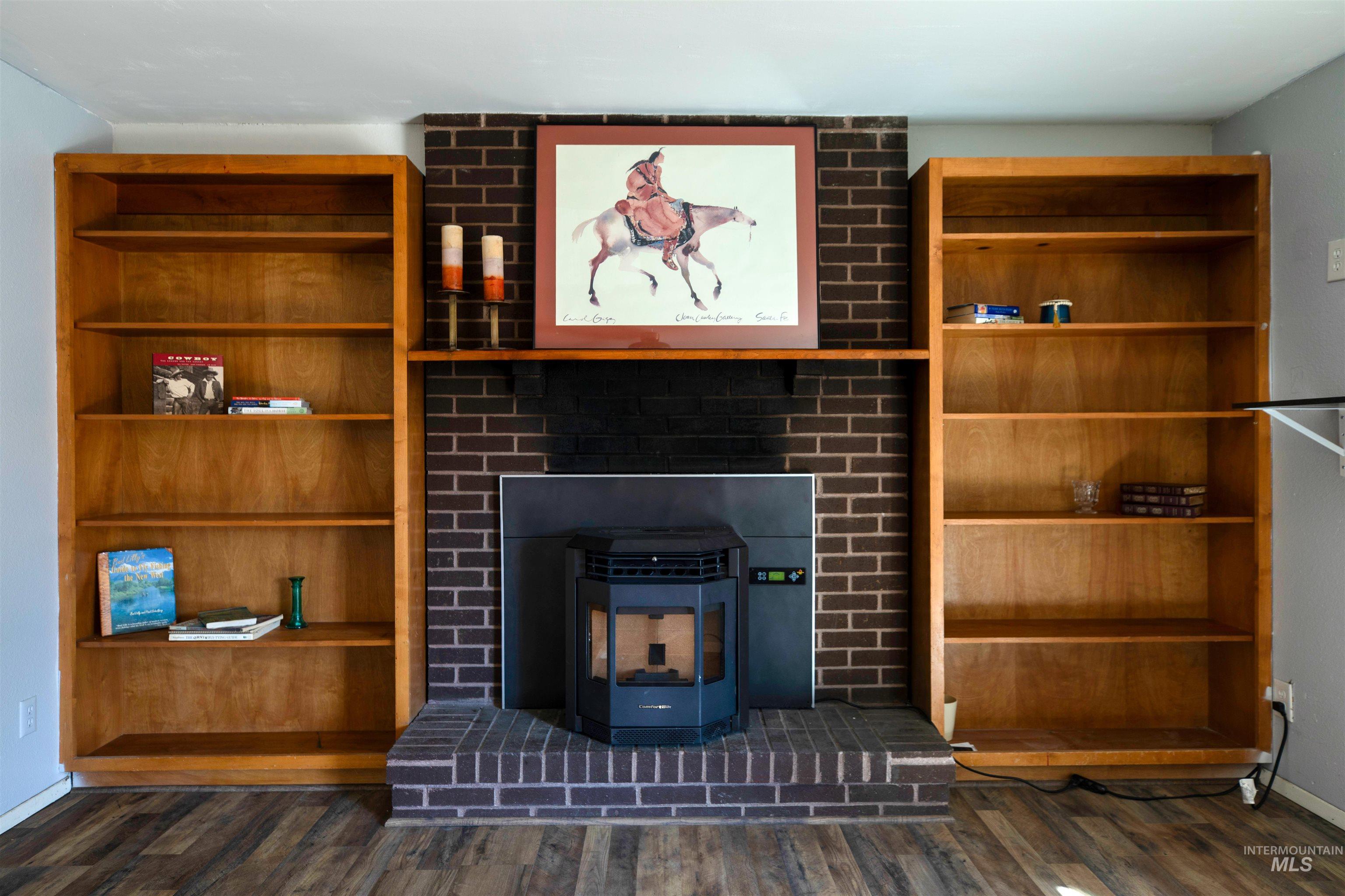 Unfurnished living room featuring a wood stove and dark wood-style floors
