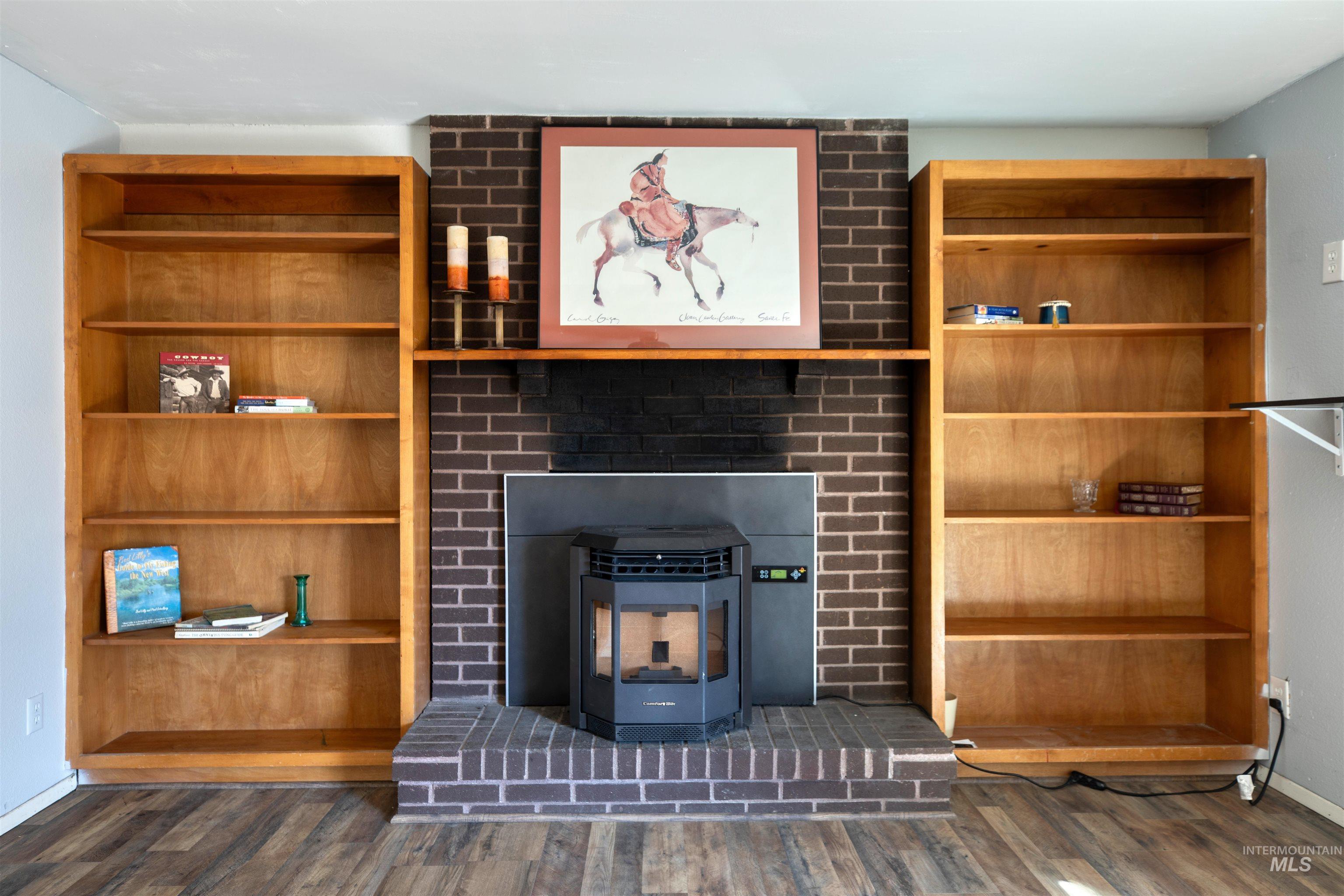 Unfurnished living room with a wood stove and dark wood-type flooring