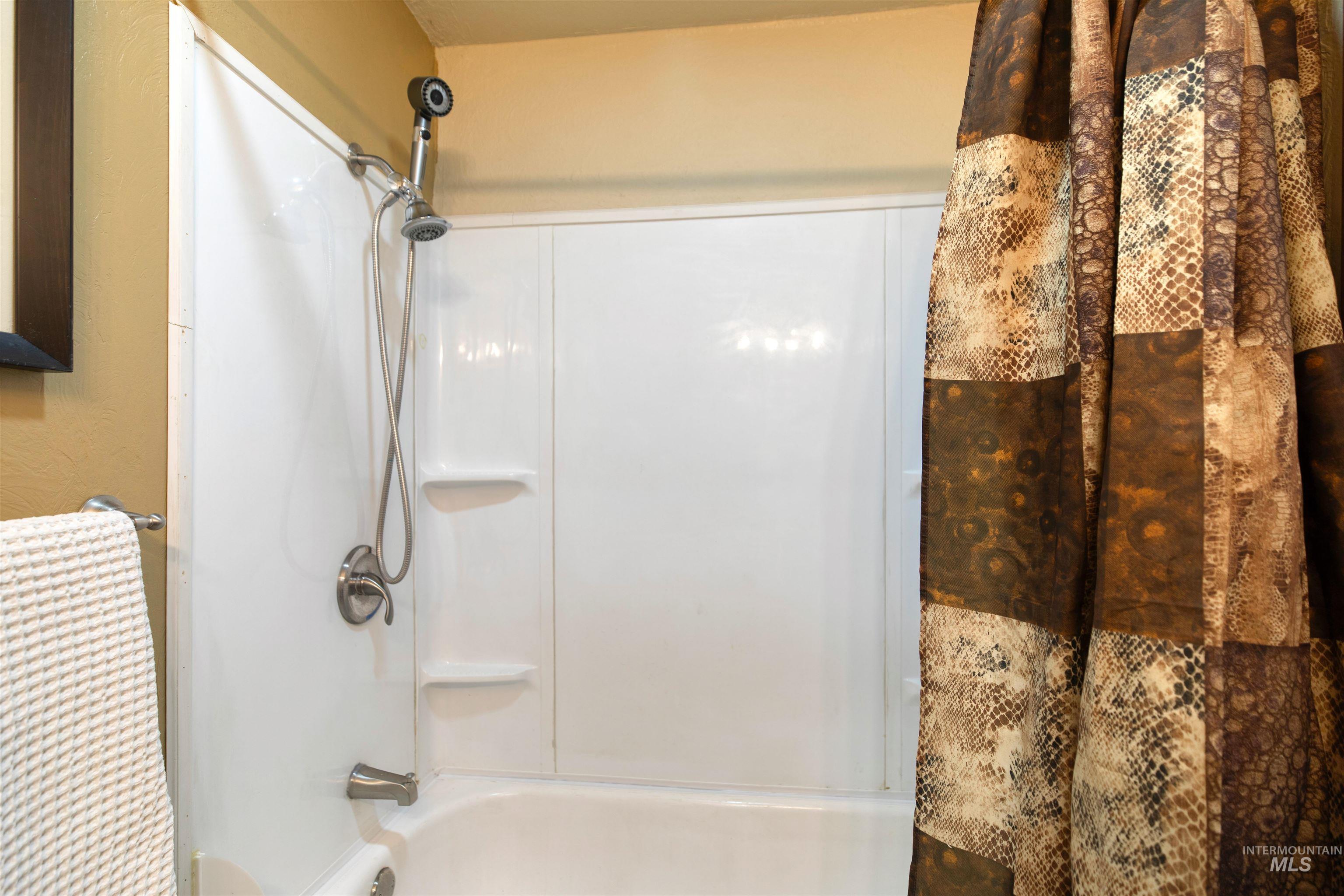 Bathroom with shower / bathtub combination with curtain