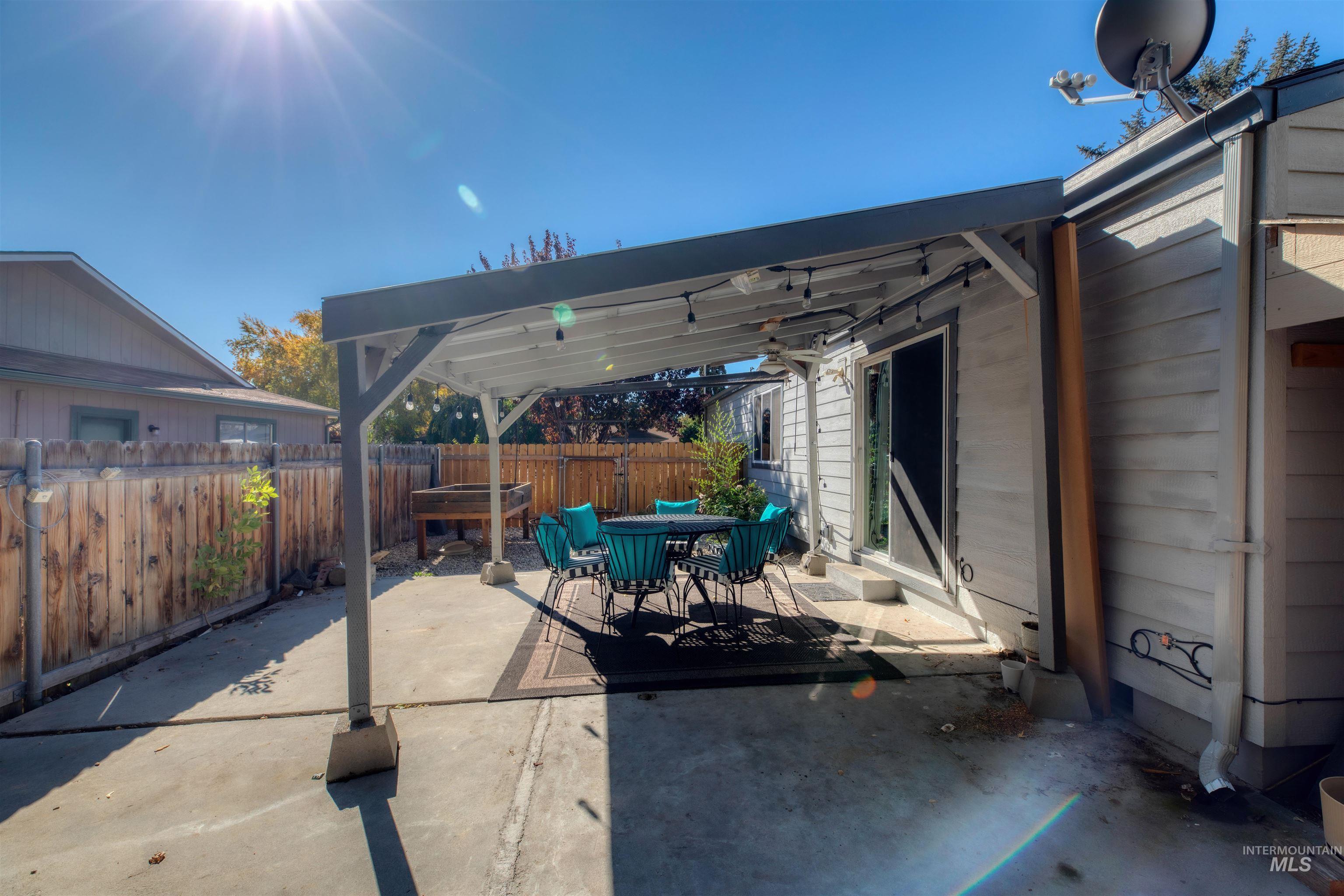 Fenced backyard featuring outdoor dining space and a patio area