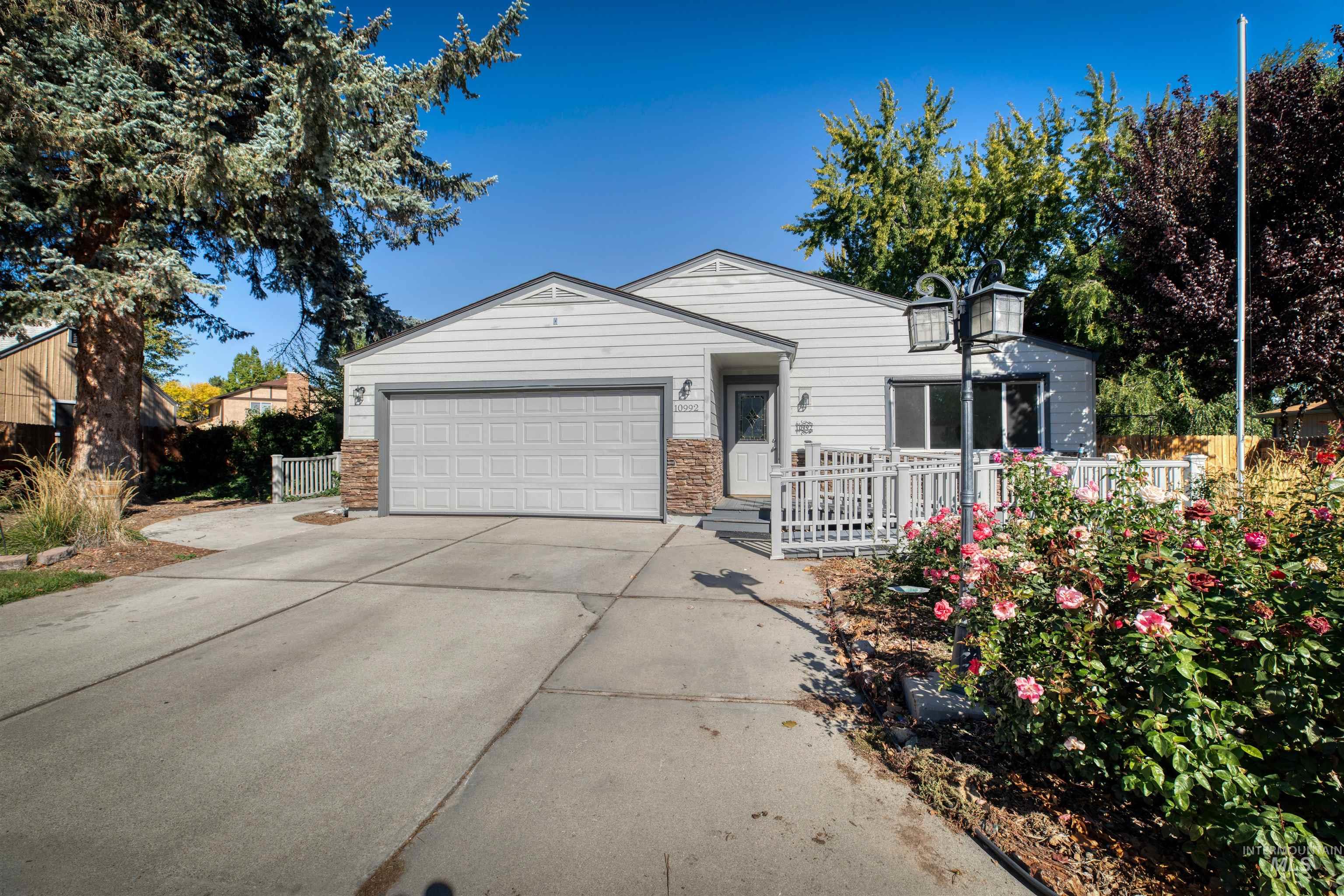 Ranch-style home with concrete driveway and a garage