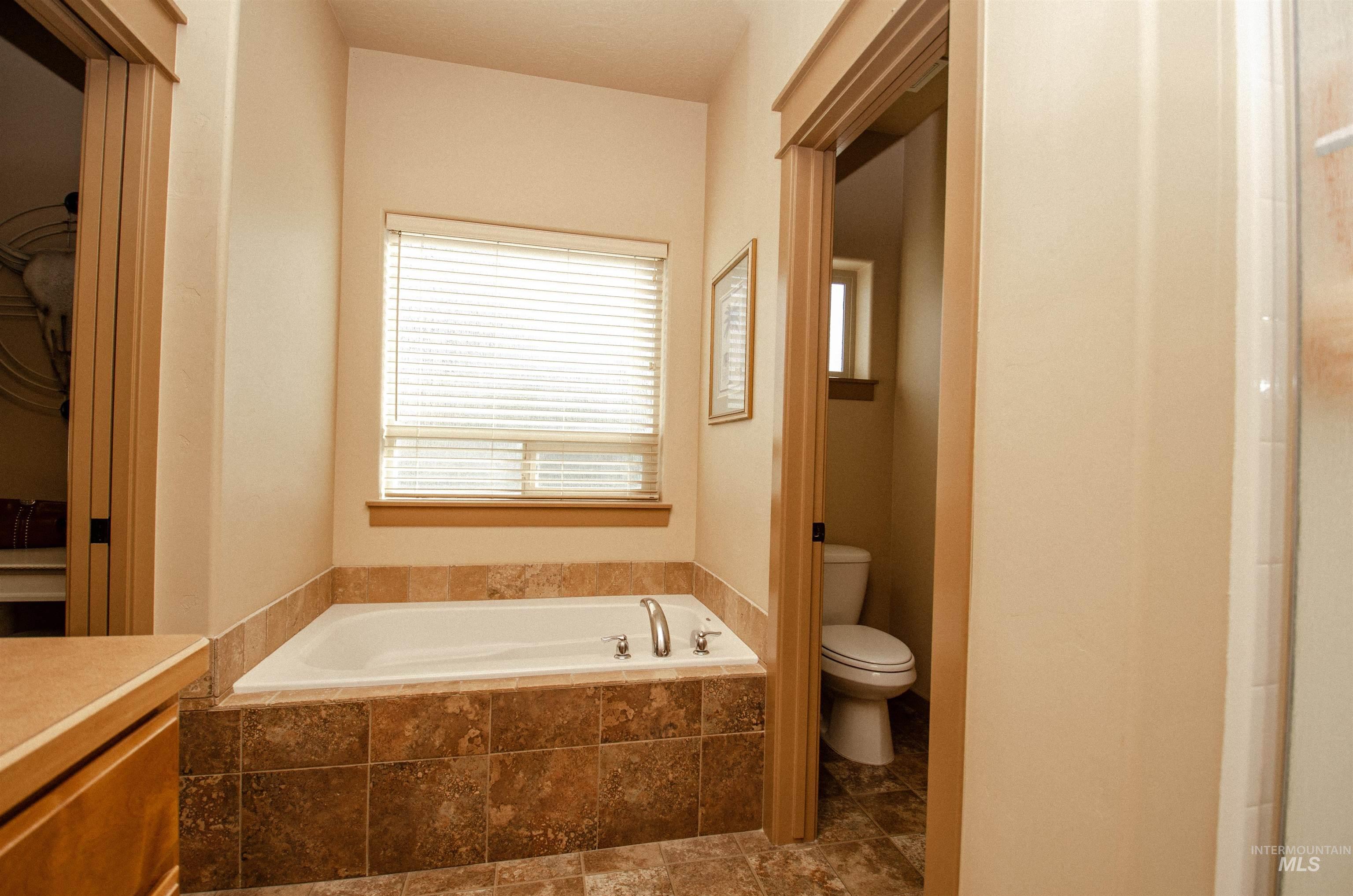 Bathroom featuring a bath and toilet