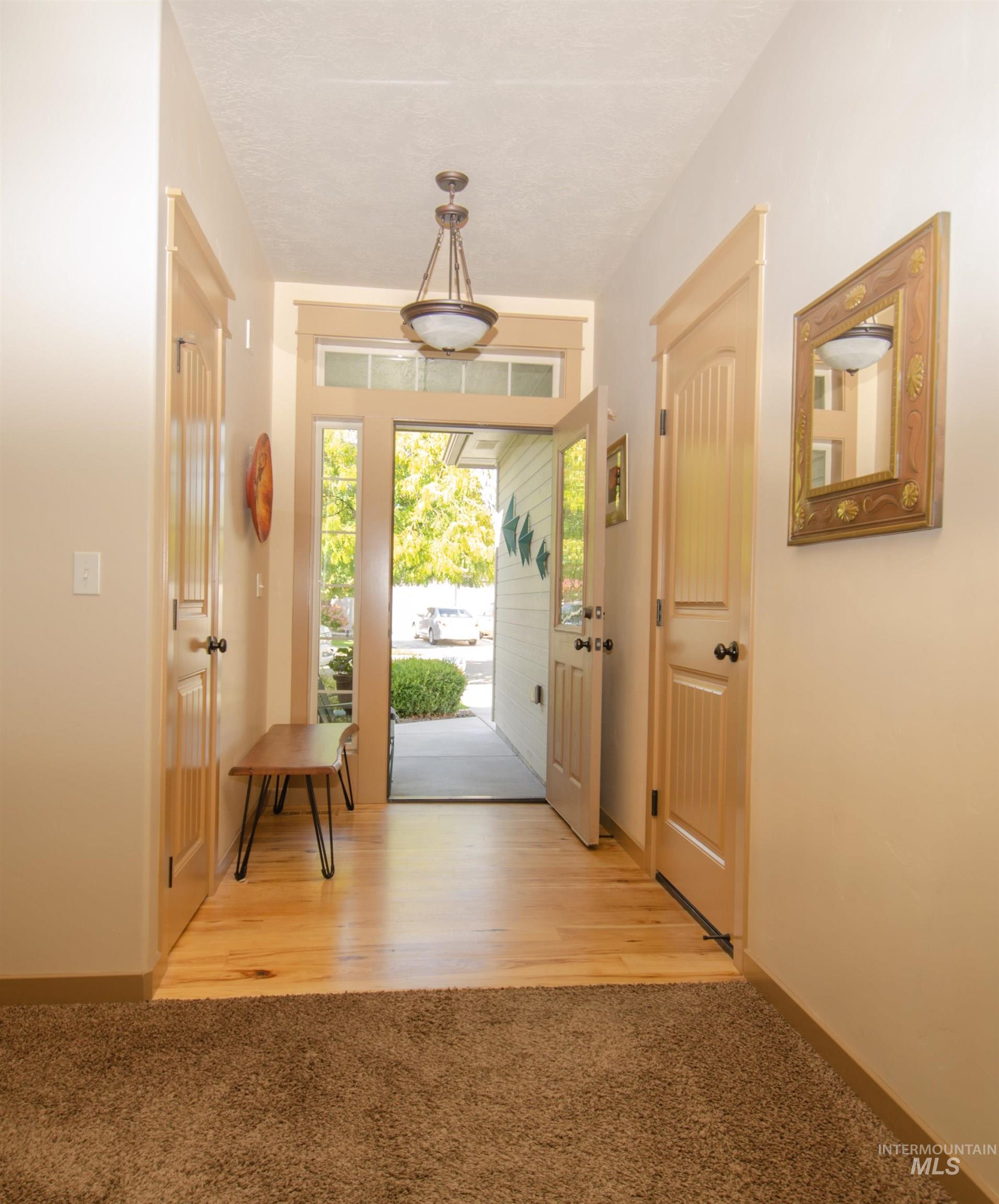 Entryway featuring carpet and wood finished floors
