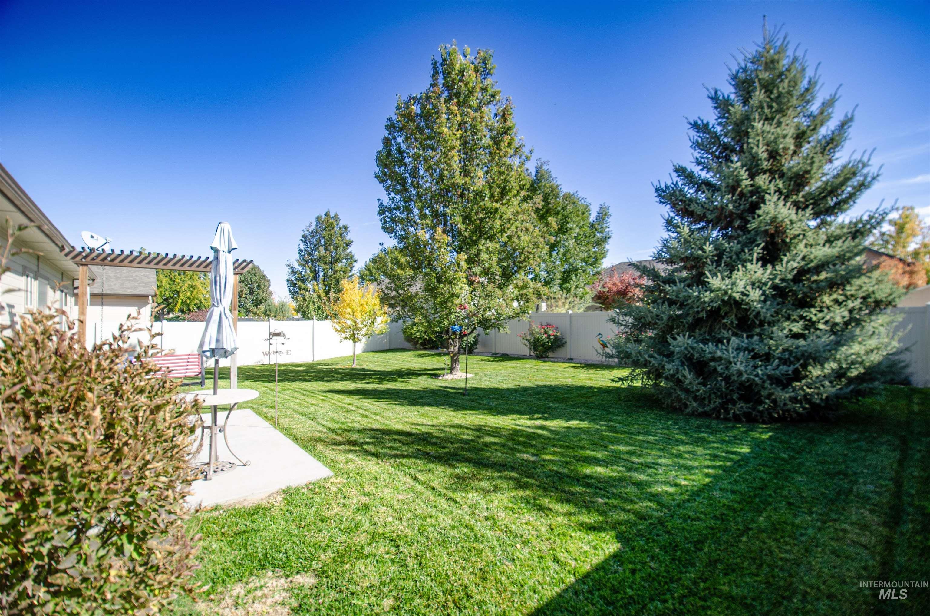 Fenced backyard with a patio area and a pergola