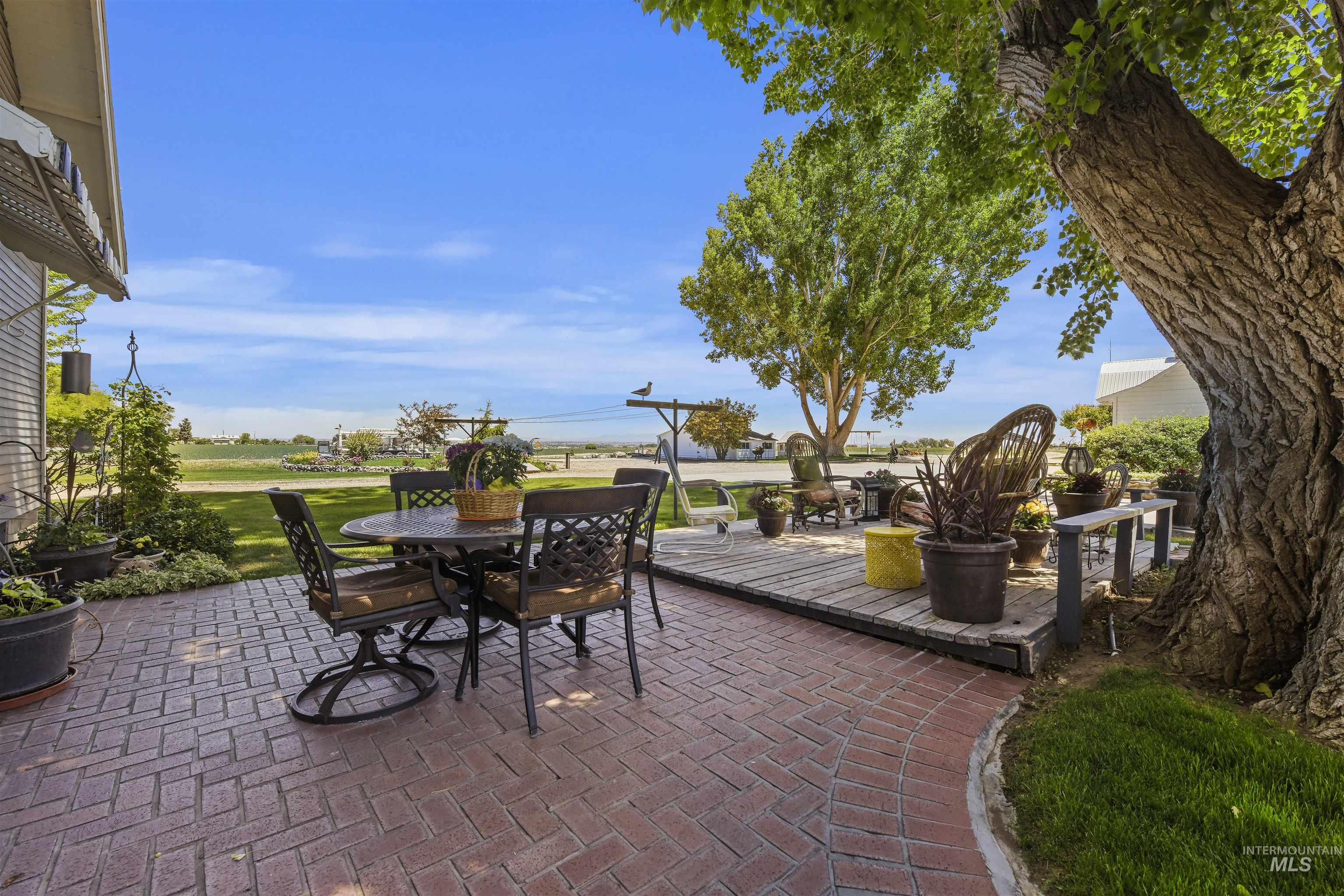 View of patio with outdoor dining space and a deck