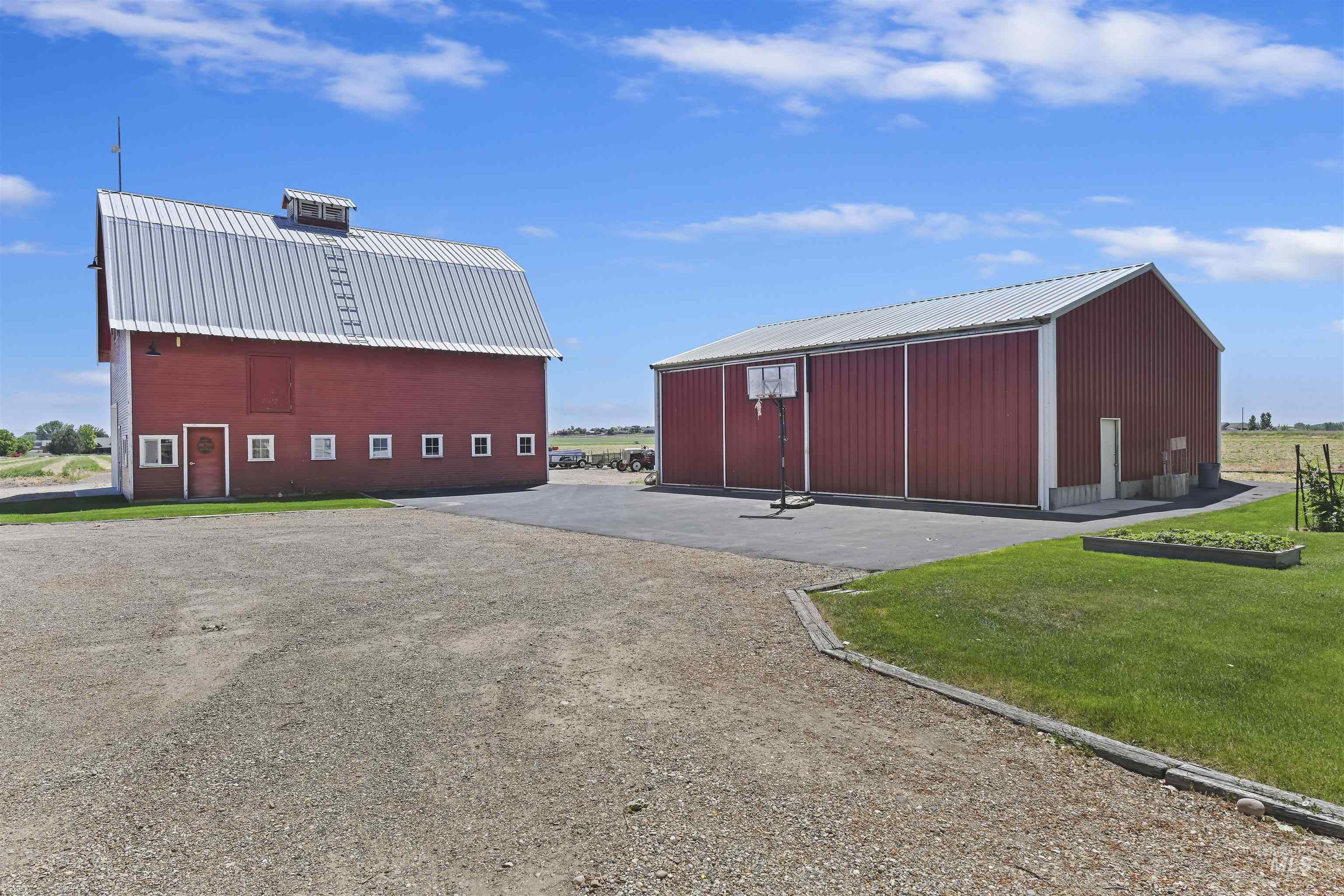 View of pole building with a yard