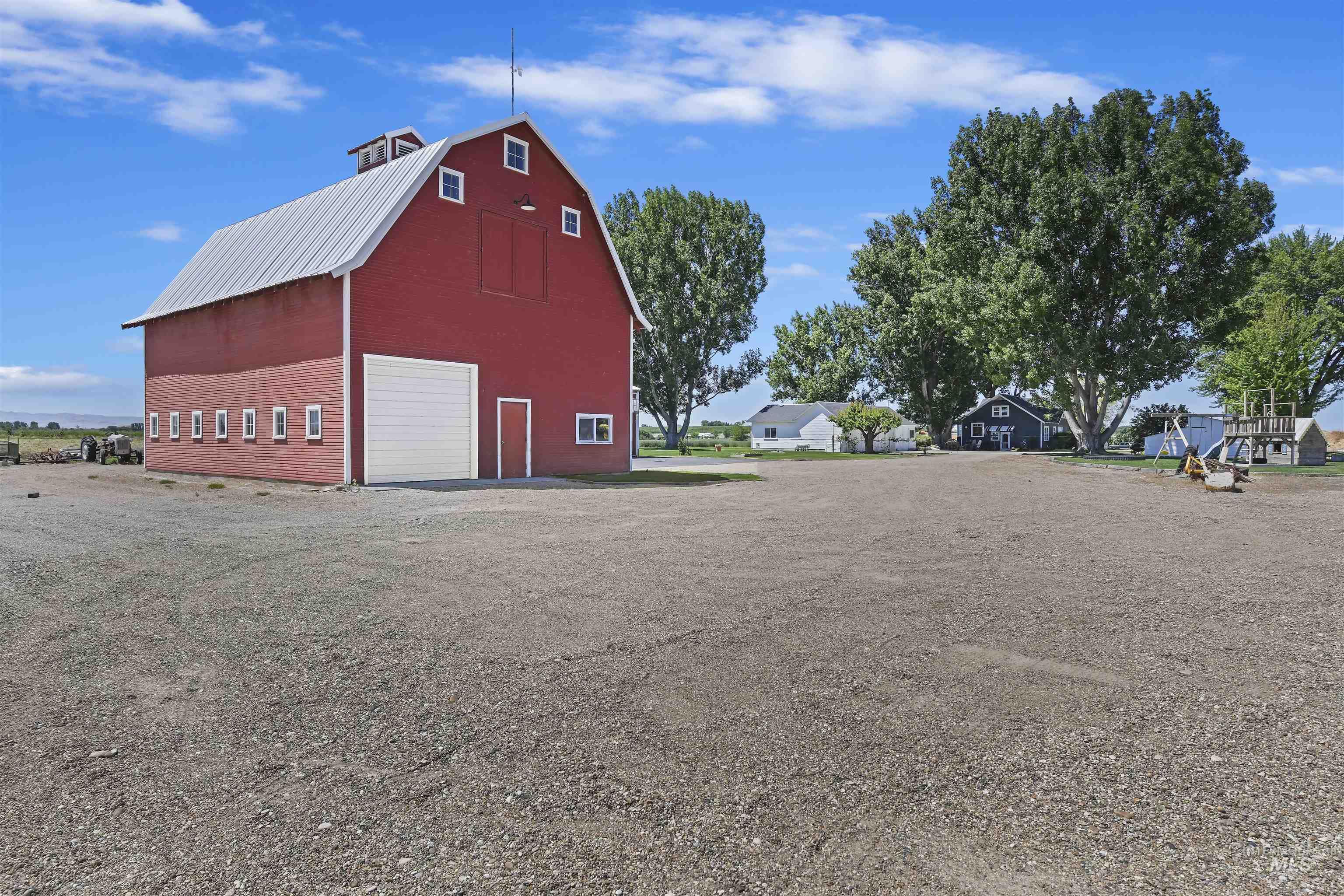 View of barn featuring driveway and a residential view