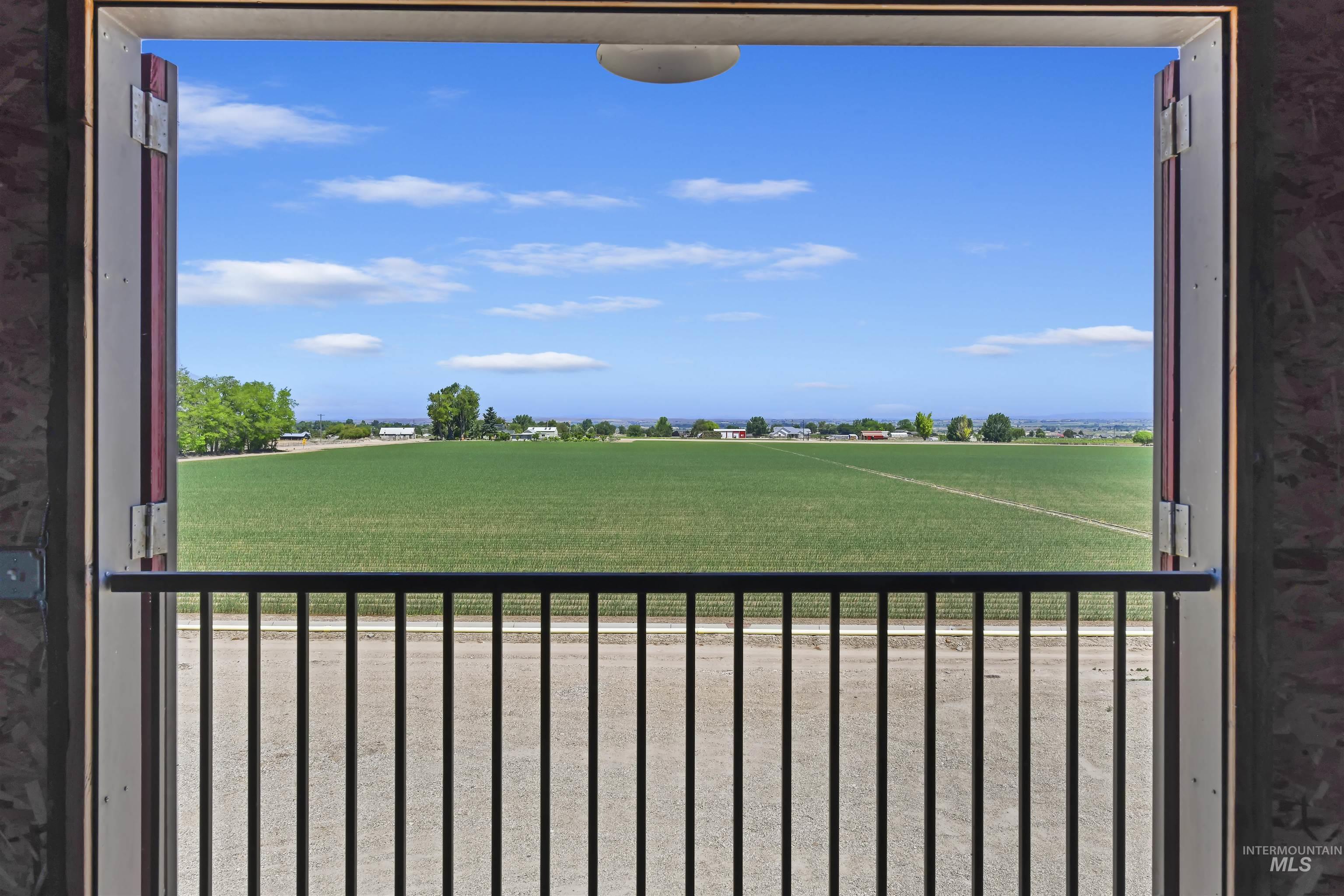 View of yard featuring a balcony and a view of countryside