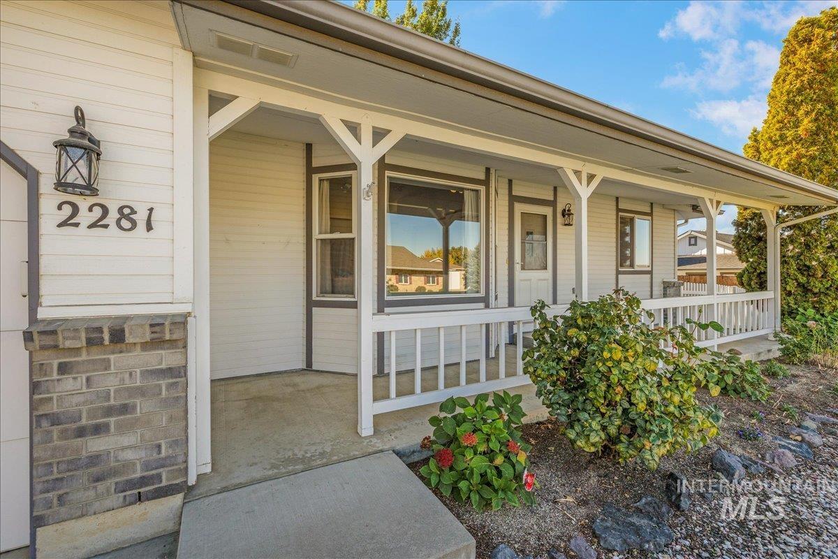 Doorway to property featuring covered porch