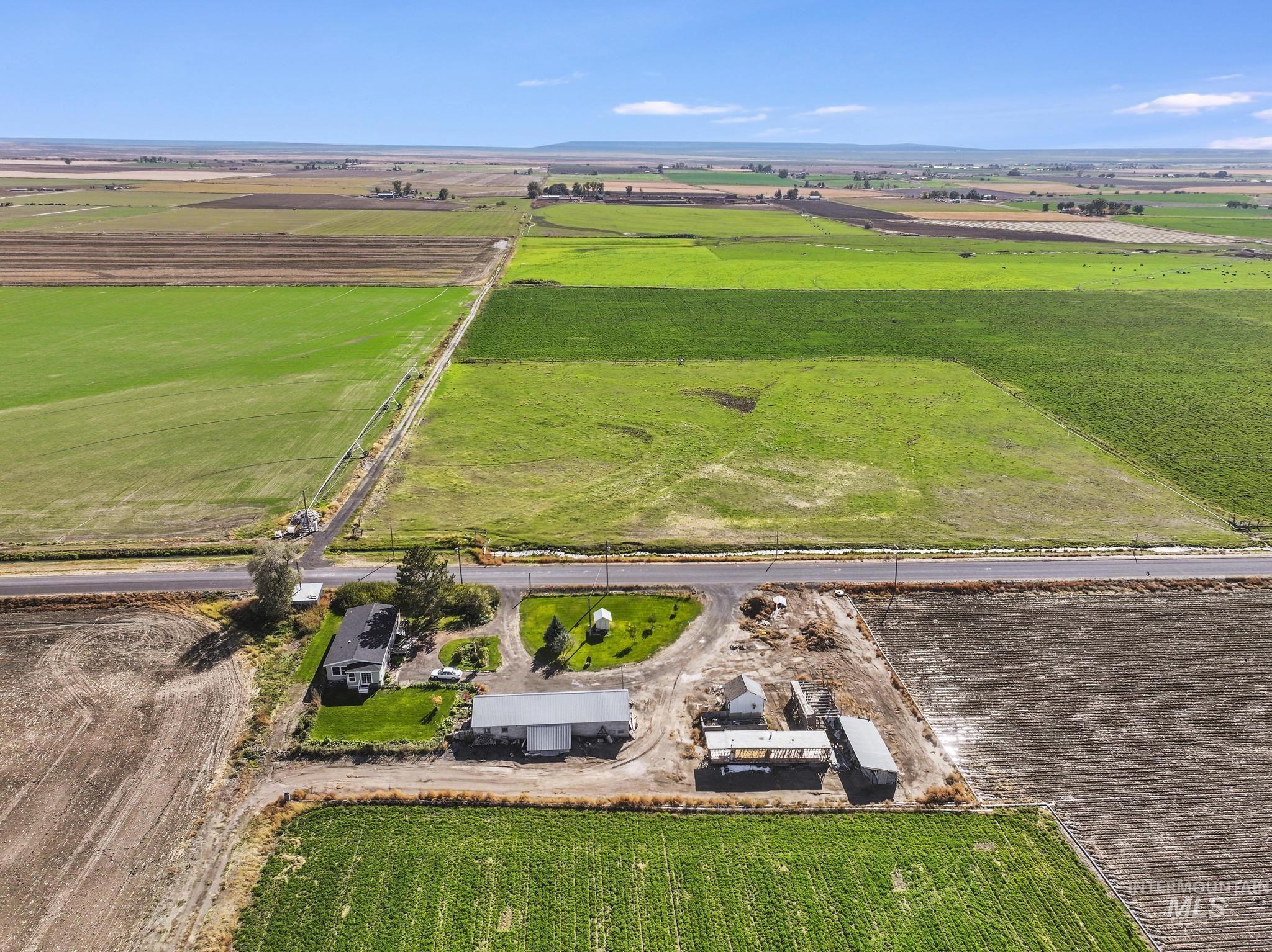 Aerial view of sparsely populated area with large plots for crops