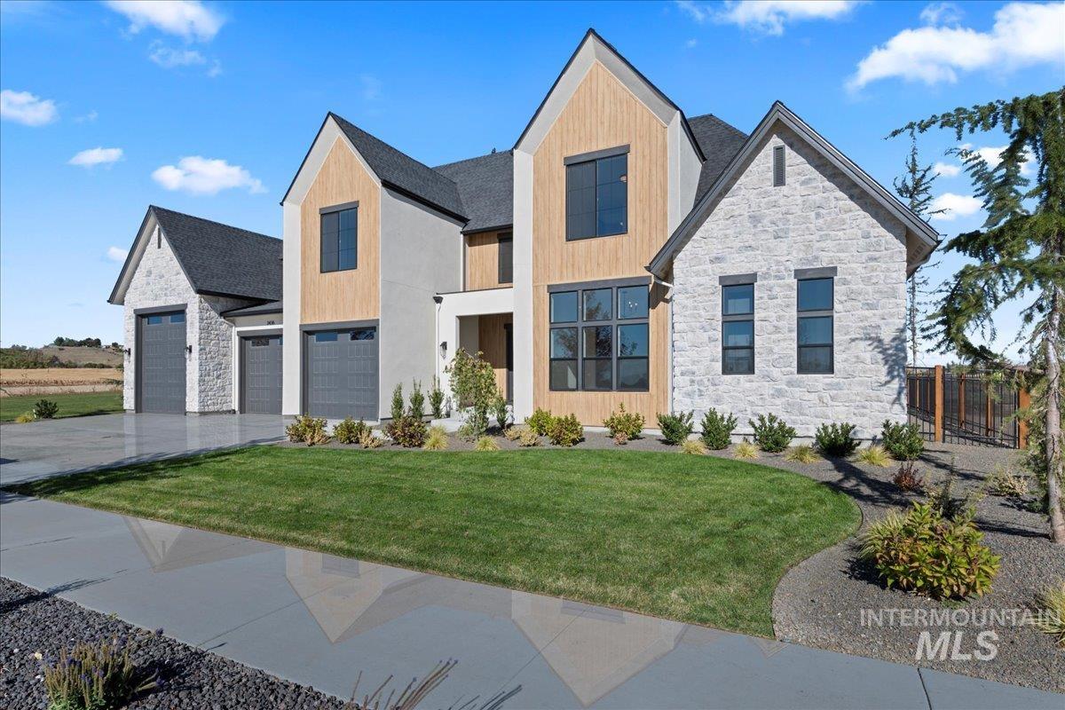 Contemporary house with stone siding and concrete driveway