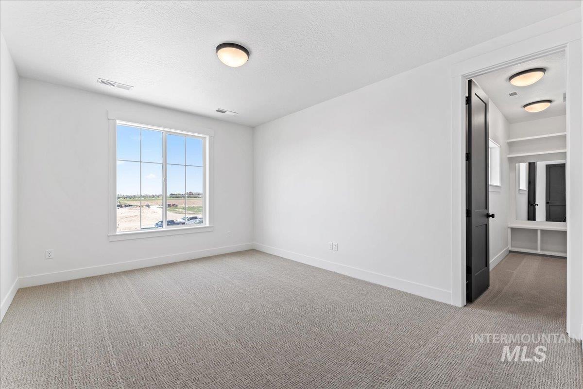 Bedroom featuring light colored carpet and amazing natural light