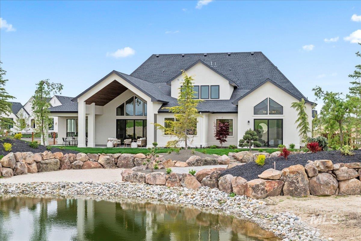 Back of house with stucco siding, a patio, and private beach
