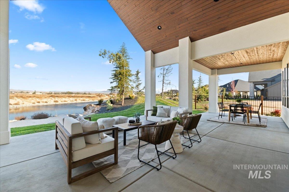 View of patio featuring an outdoor hangout area, outdoor dining space, and a water view