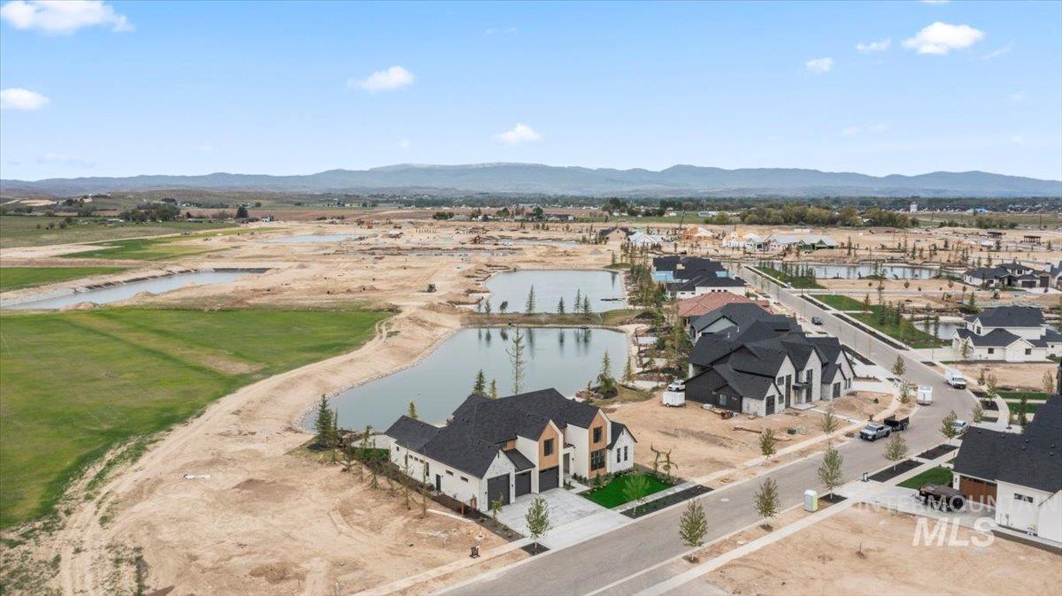 Aerial view of residential area featuring a water and mountain view