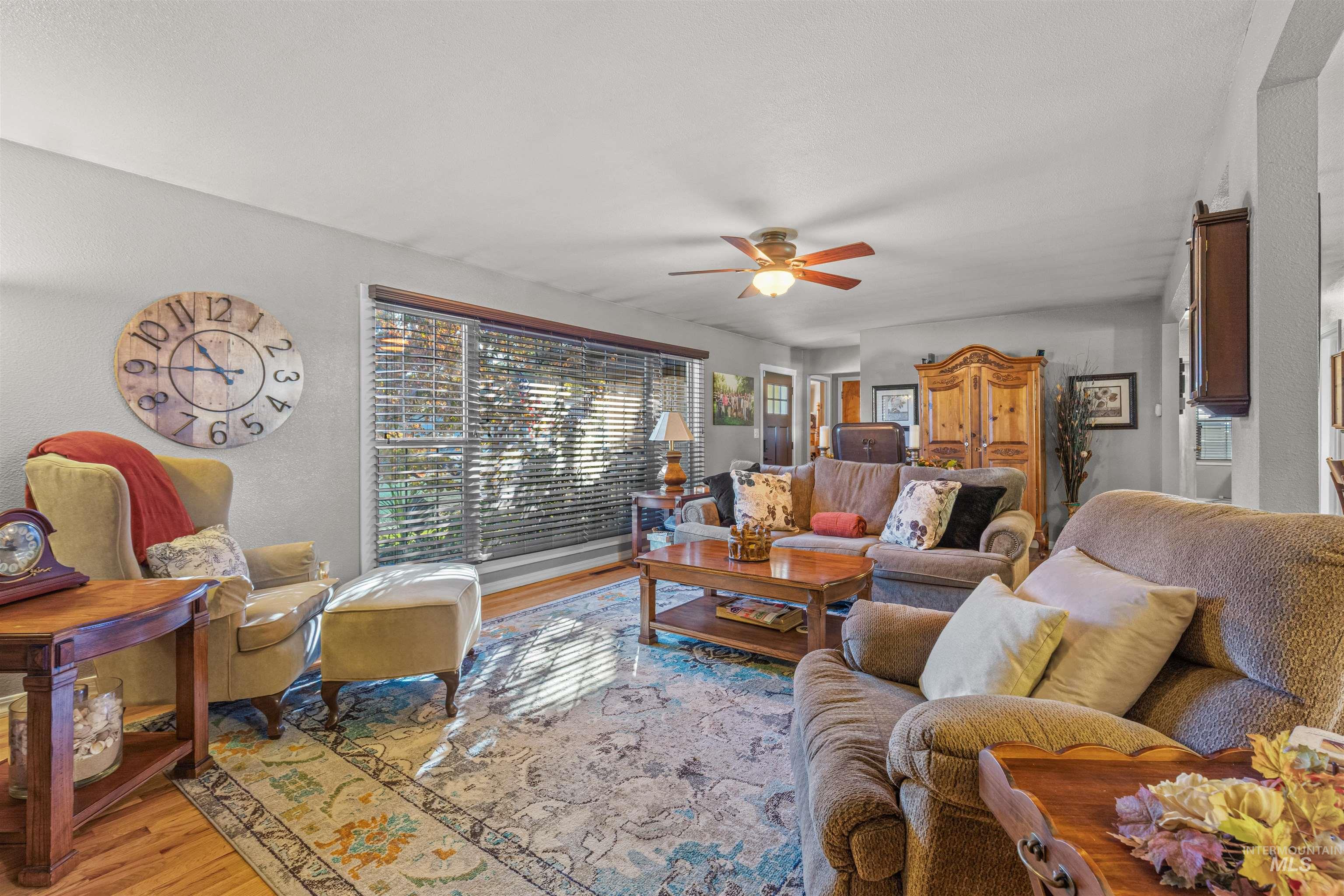 Living area featuring wood finished floors and ceiling fan