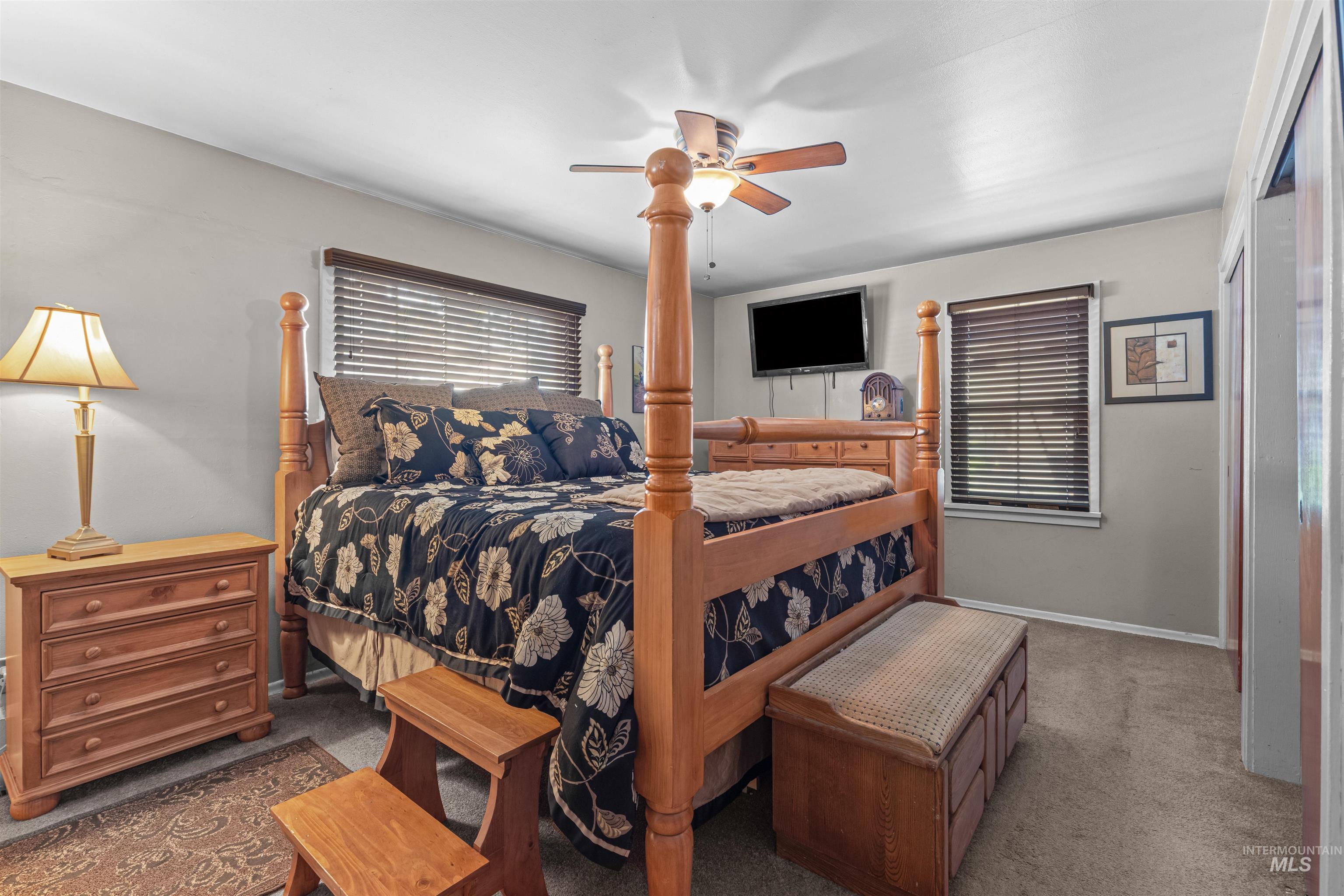 Main Floor Carpeted bedroom featuring a ceiling fan and baseboards