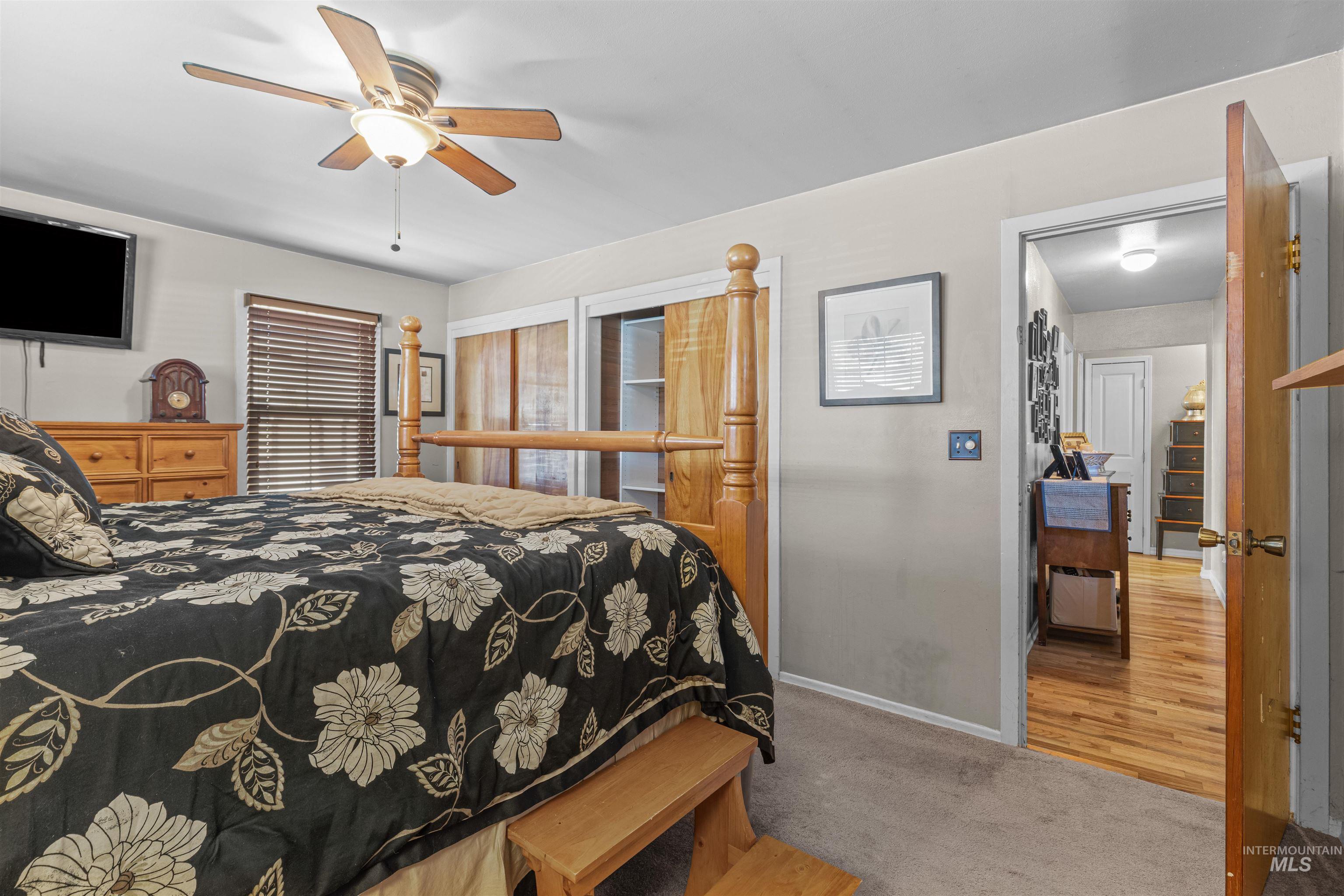 Main Floor Bedroom featuring carpet and a ceiling fan