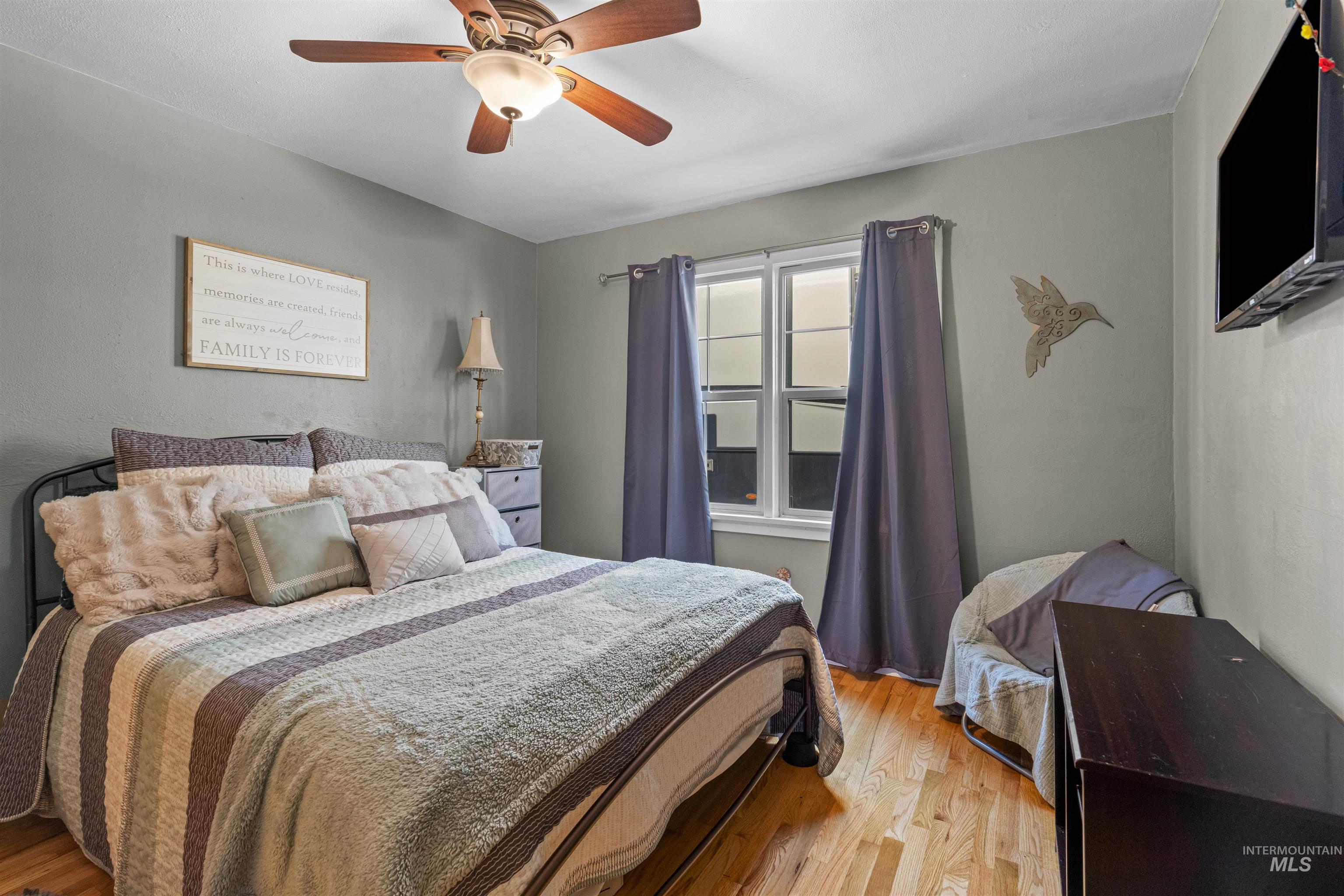 Main Floor Bedroom featuring wood finished floors and ceiling fan