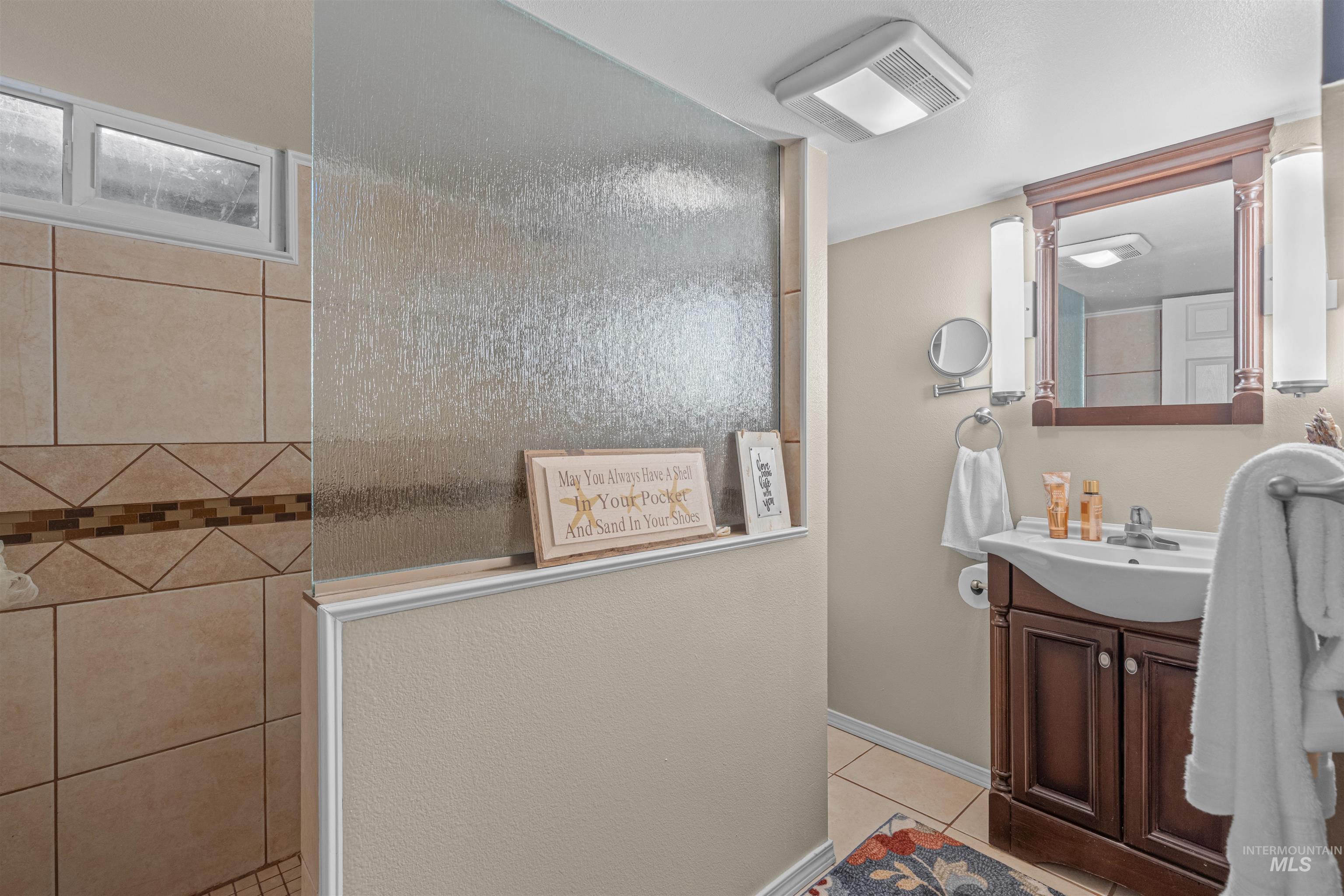 Bathroom featuring vanity and light tile patterned flooring