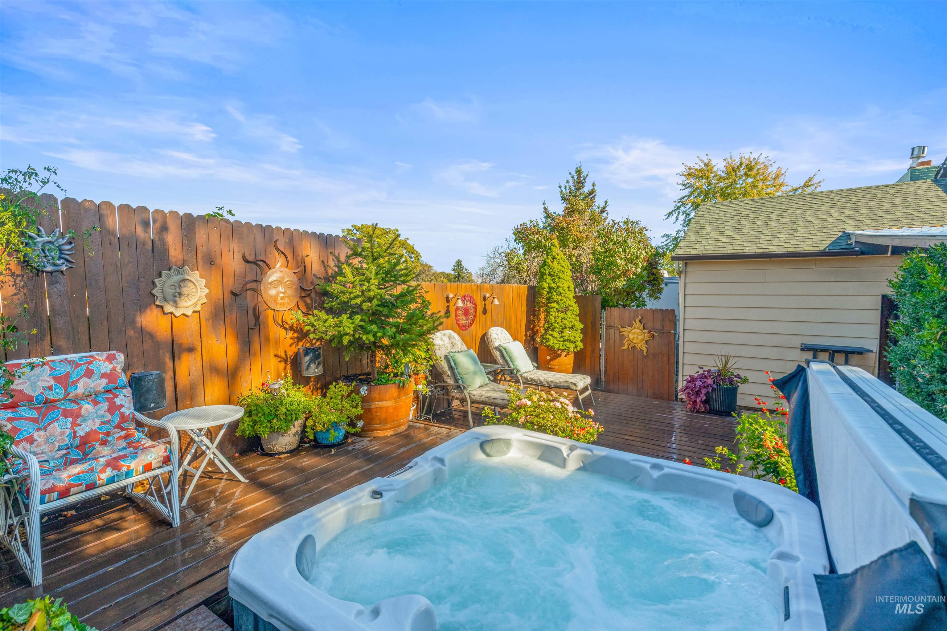 Wooden terrace featuring an outdoor hot tub