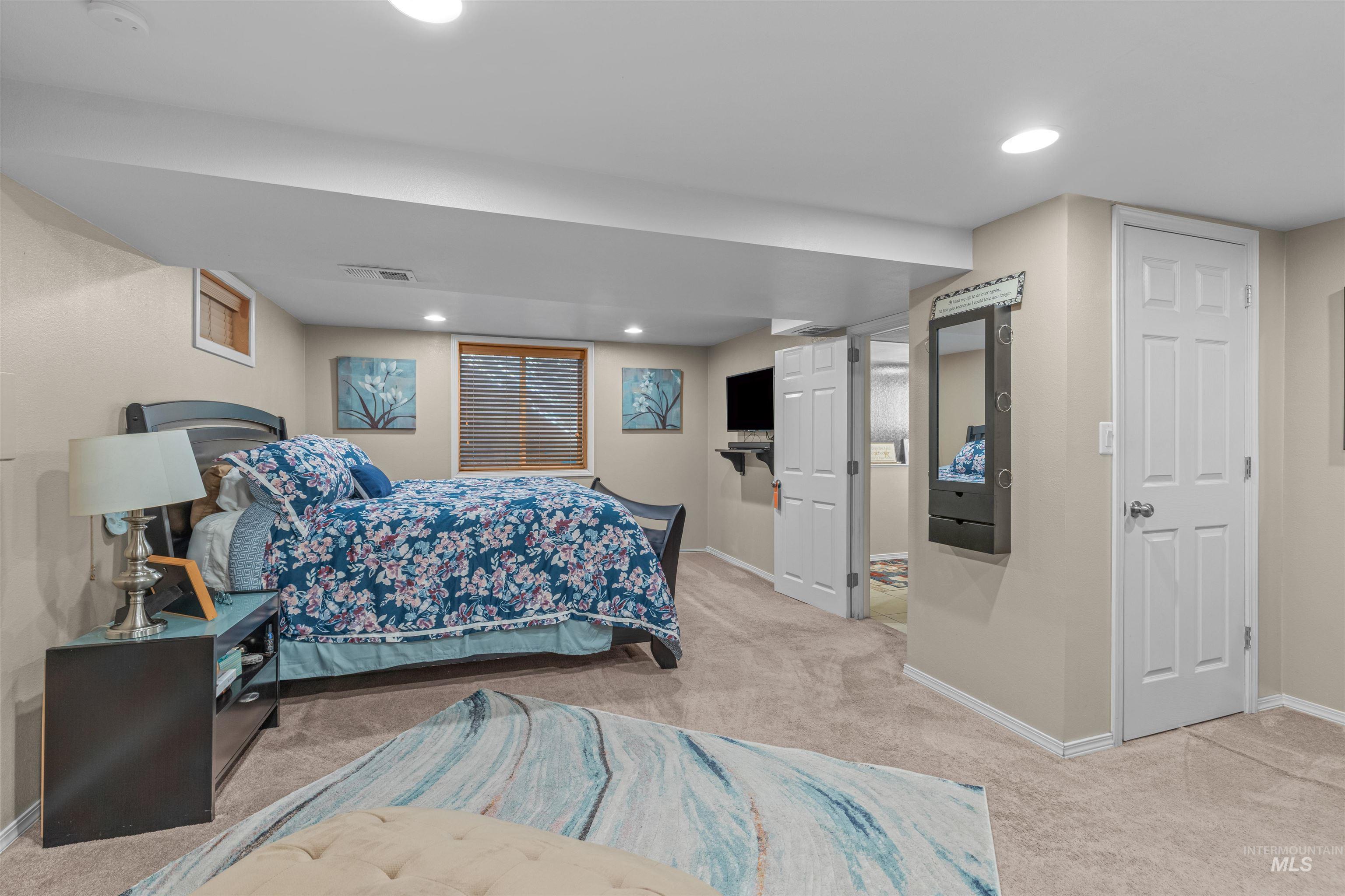 Bedroom featuring light colored carpet and recessed lighting