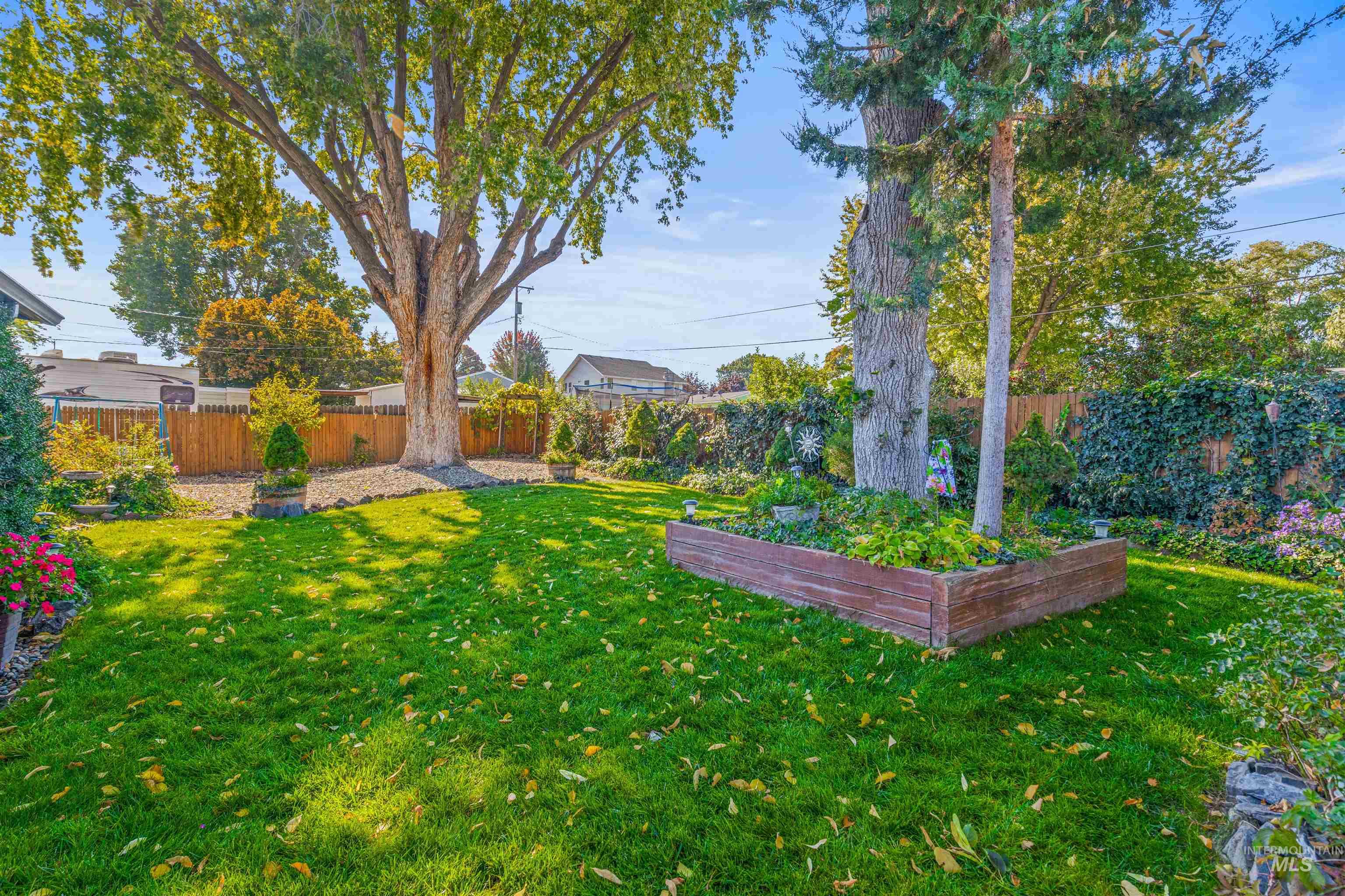 Fenced backyard with a vegetable garden
