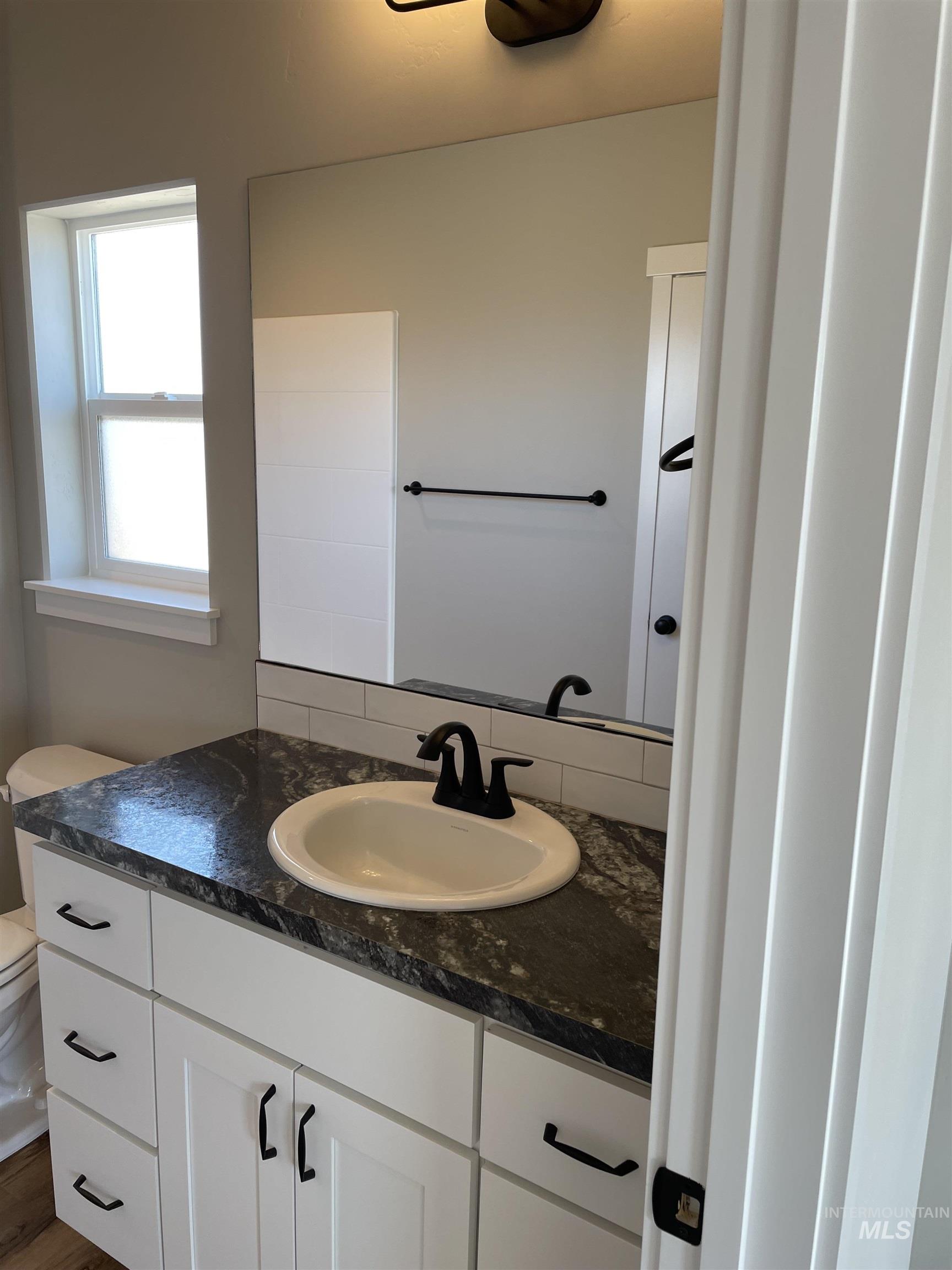 Bathroom featuring vanity and toilet