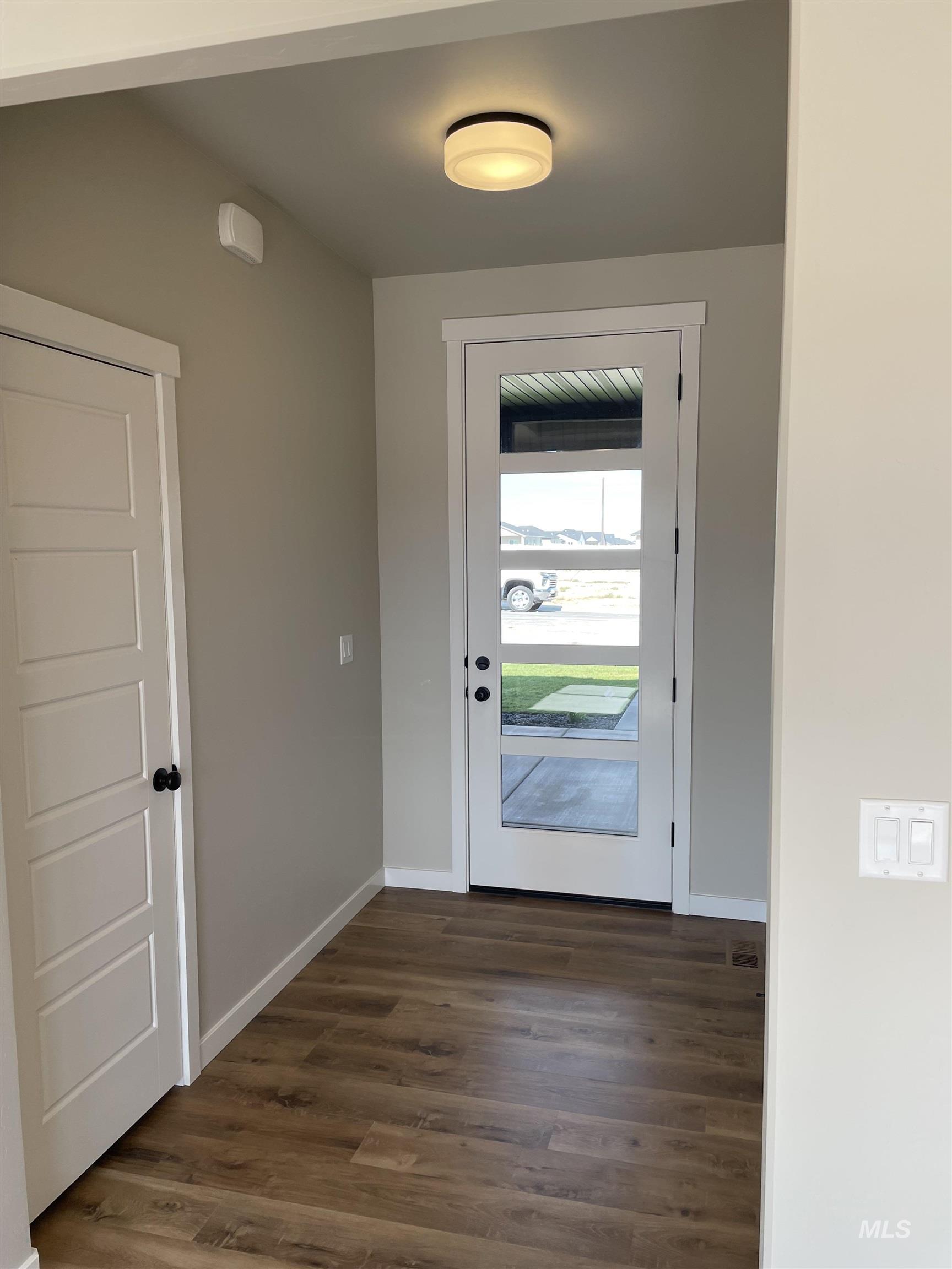 Entryway featuring wood finished floors and baseboards