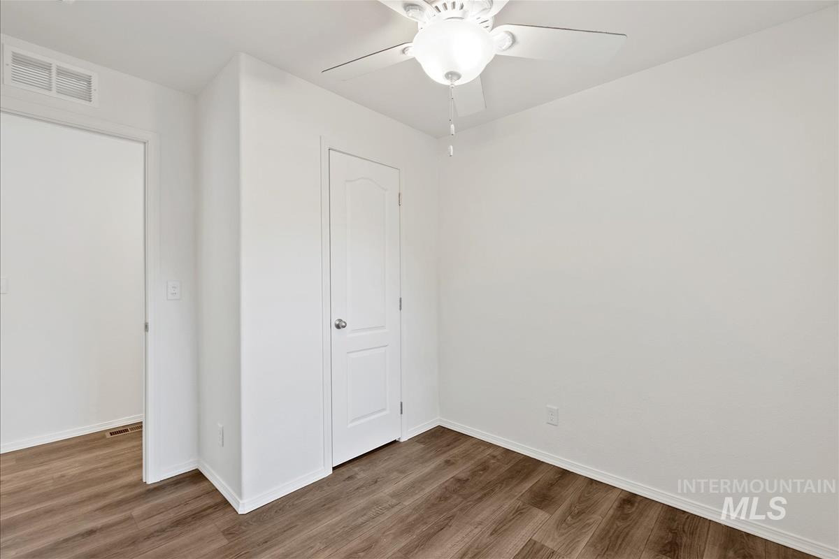 Unfurnished bedroom with wood finished floors and ceiling fan