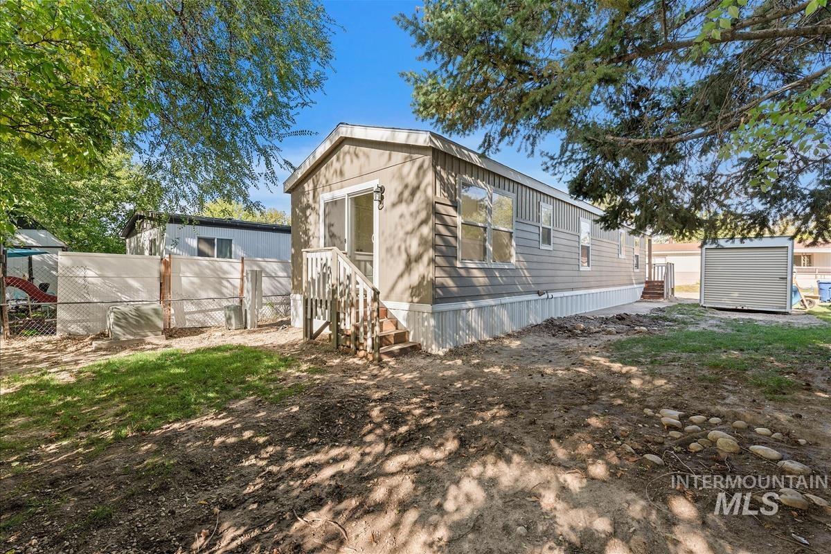 Rear view of property with an outbuilding and entry steps