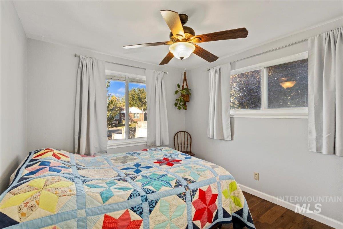 Bedroom featuring dark wood-type flooring and a ceiling fan