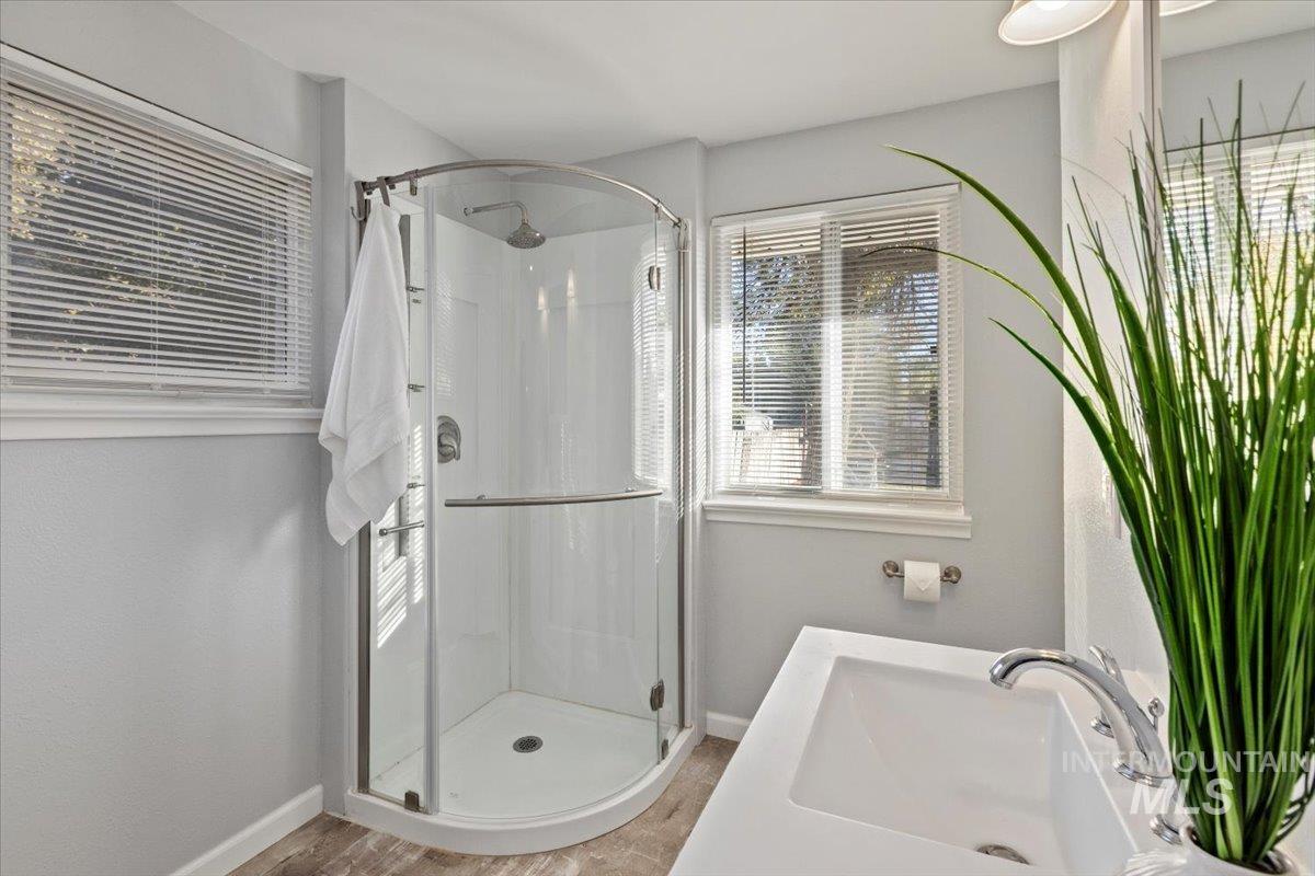 Full bath with a shower stall and vanity